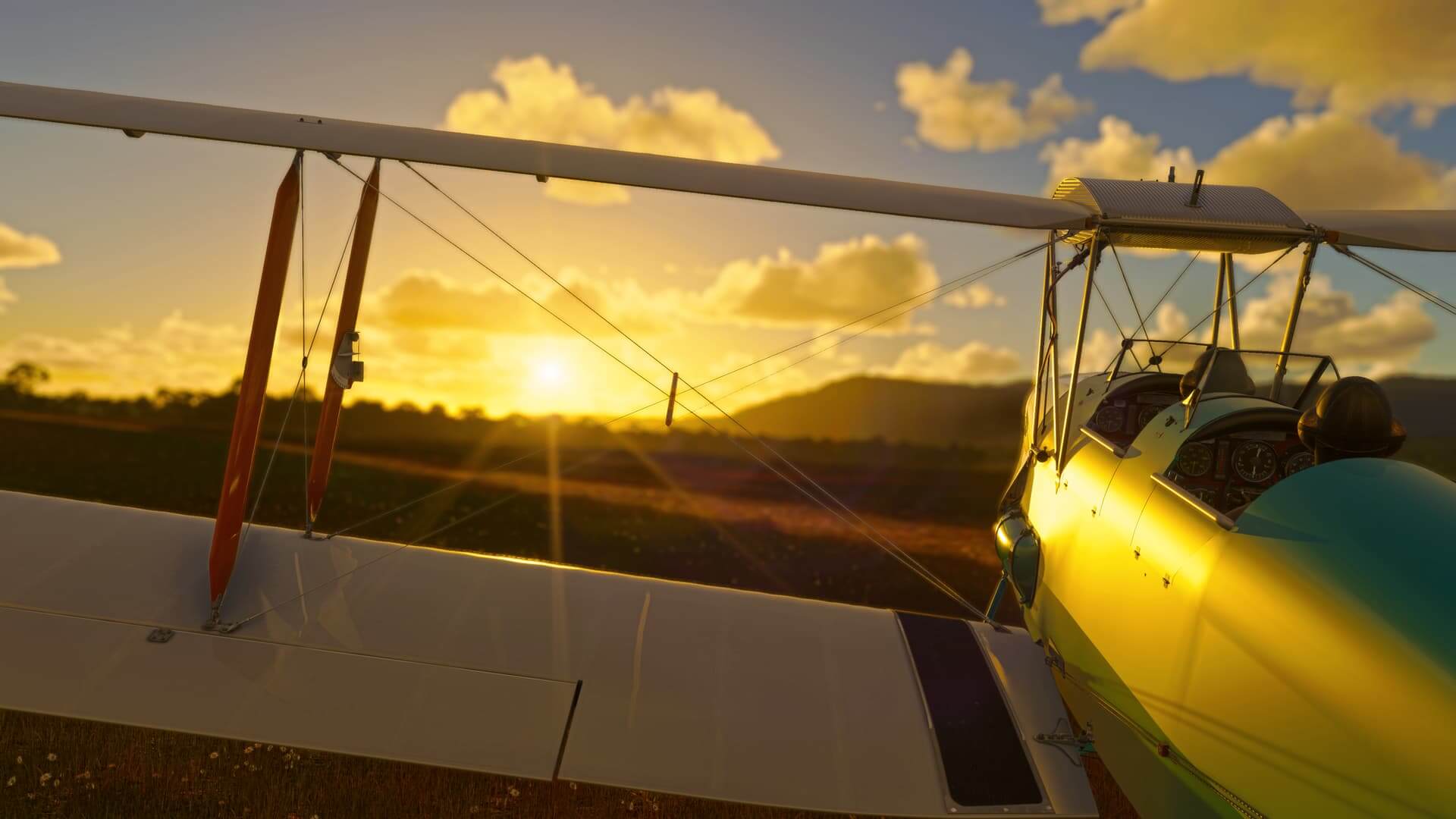 A dual-wing propeller aircraft with both pilots looking towards the sun setting in the distance