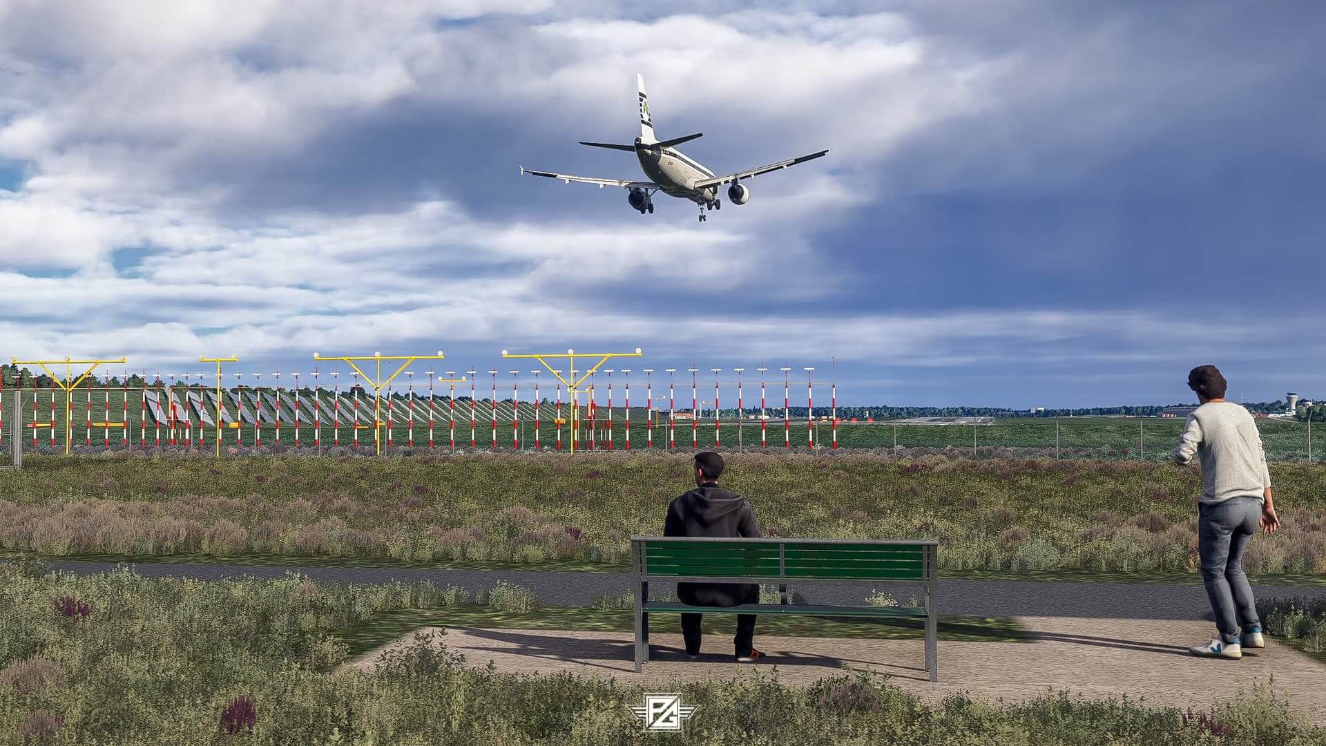 Two plane spotters watch an Airbus A320 on short final to land at an international airport