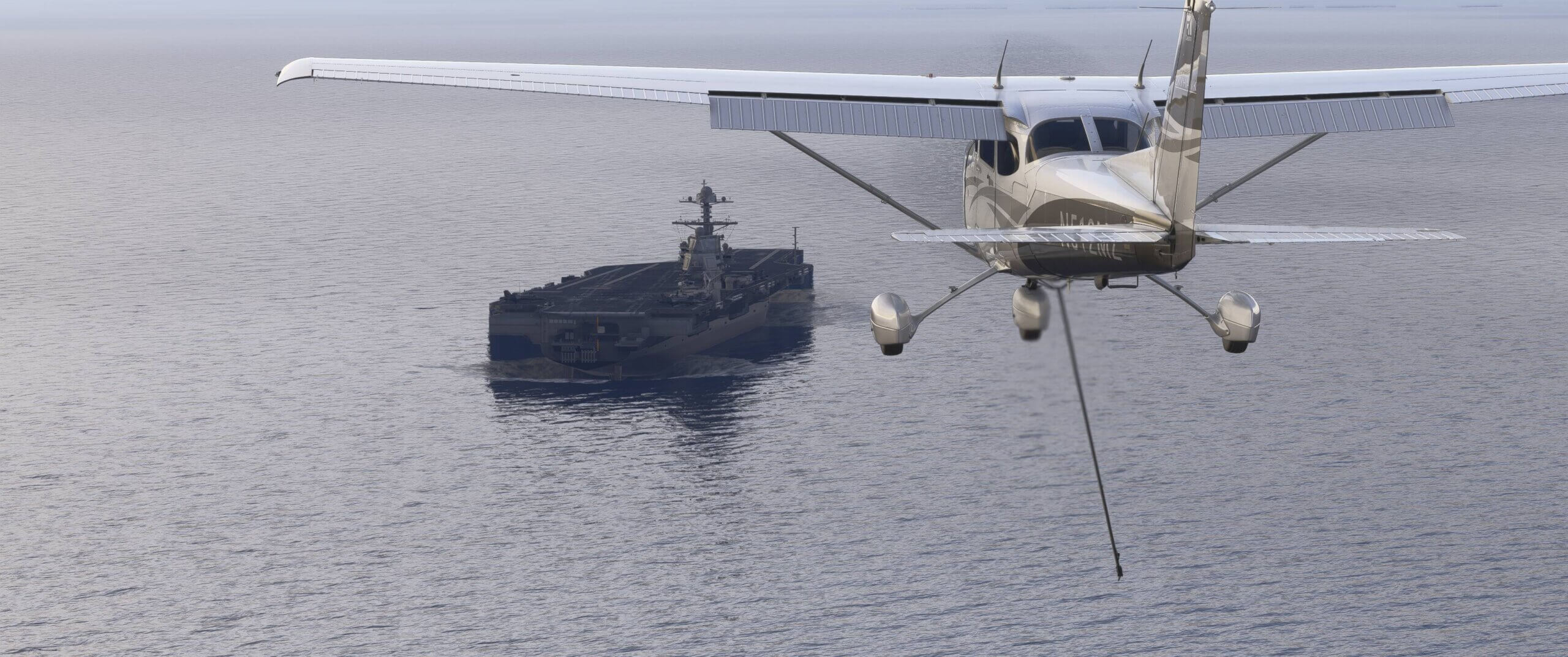 A Cessna 172 approaches an aircraft carrier with landing hook deployed