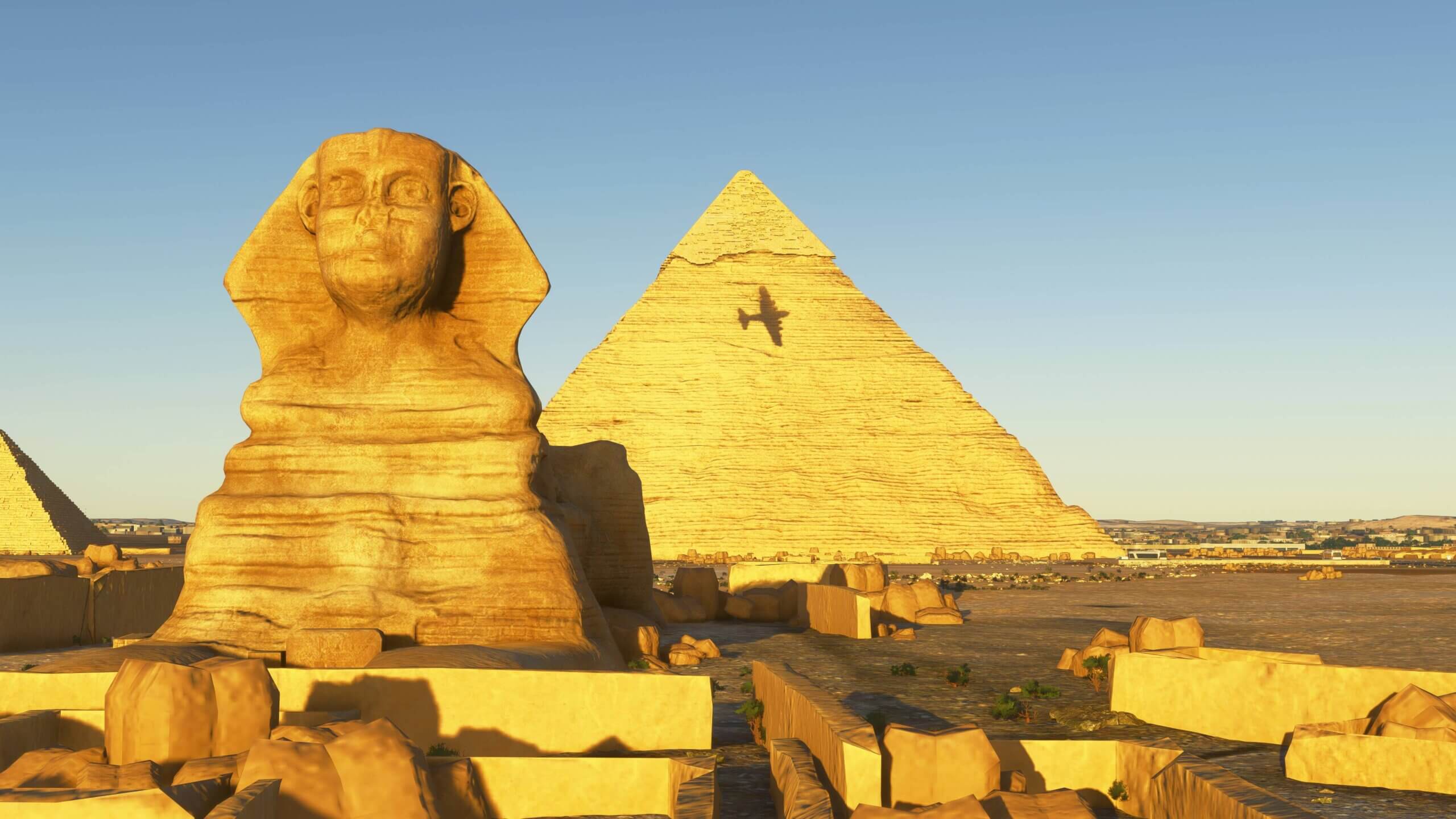 The view of a vintage aircraft shadow silhouetted against the Pyramids of Giza, Egypt