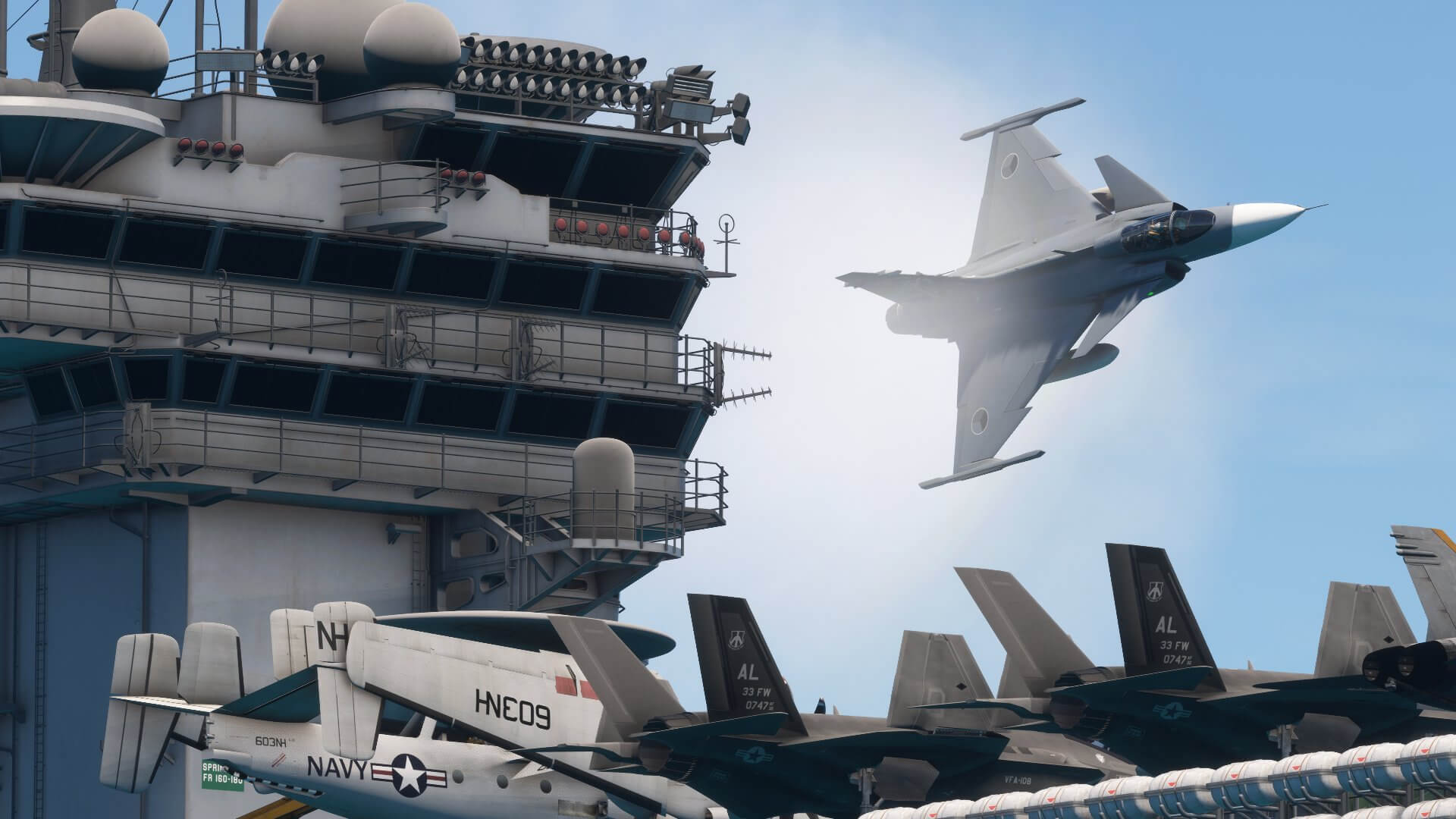 A fighter jet banks sharply to the right whilst buzzing the tower of a carrier ship
