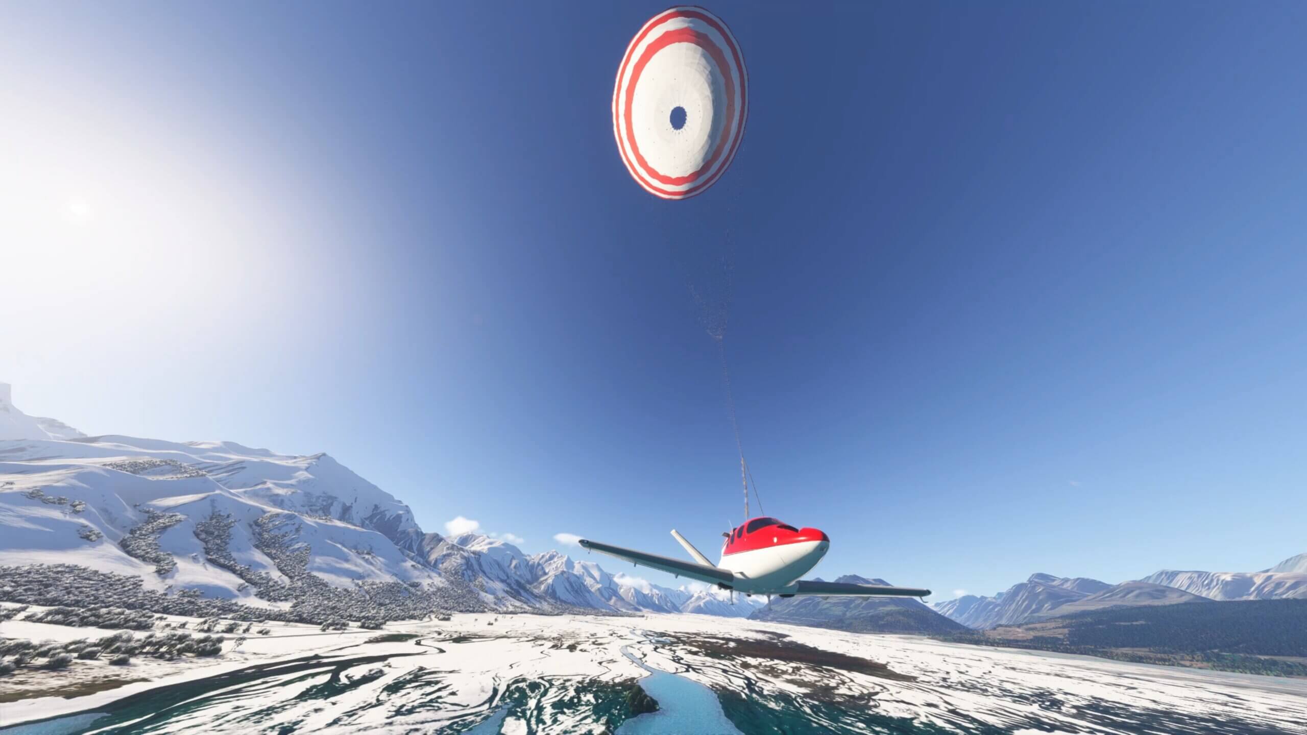 A Cirrus Vision Jet has the emergency parachute deployed above in a snowy landscape