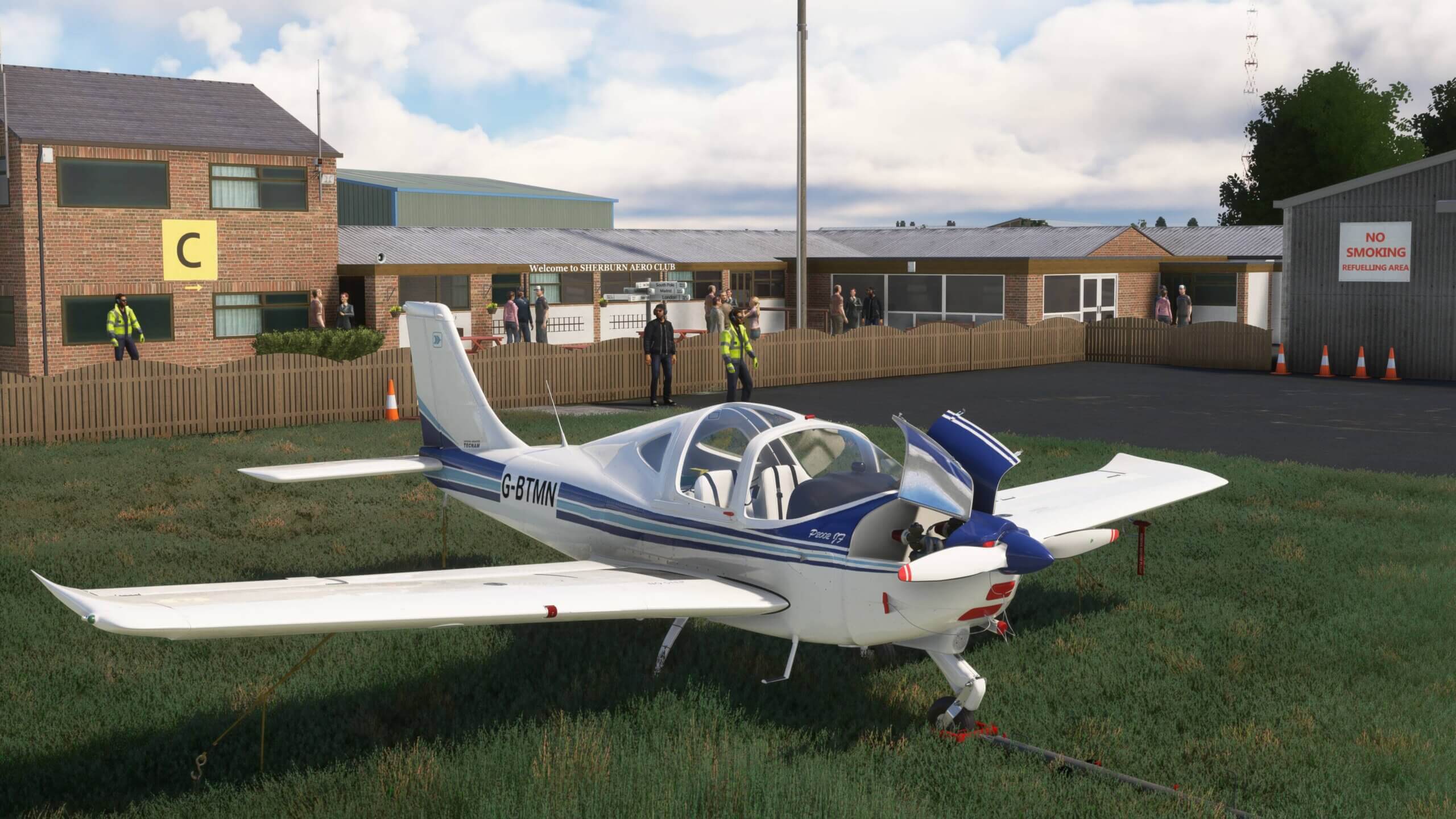 A blue general aviation aircraft sits with engine covers open at Sherburn Aero Club