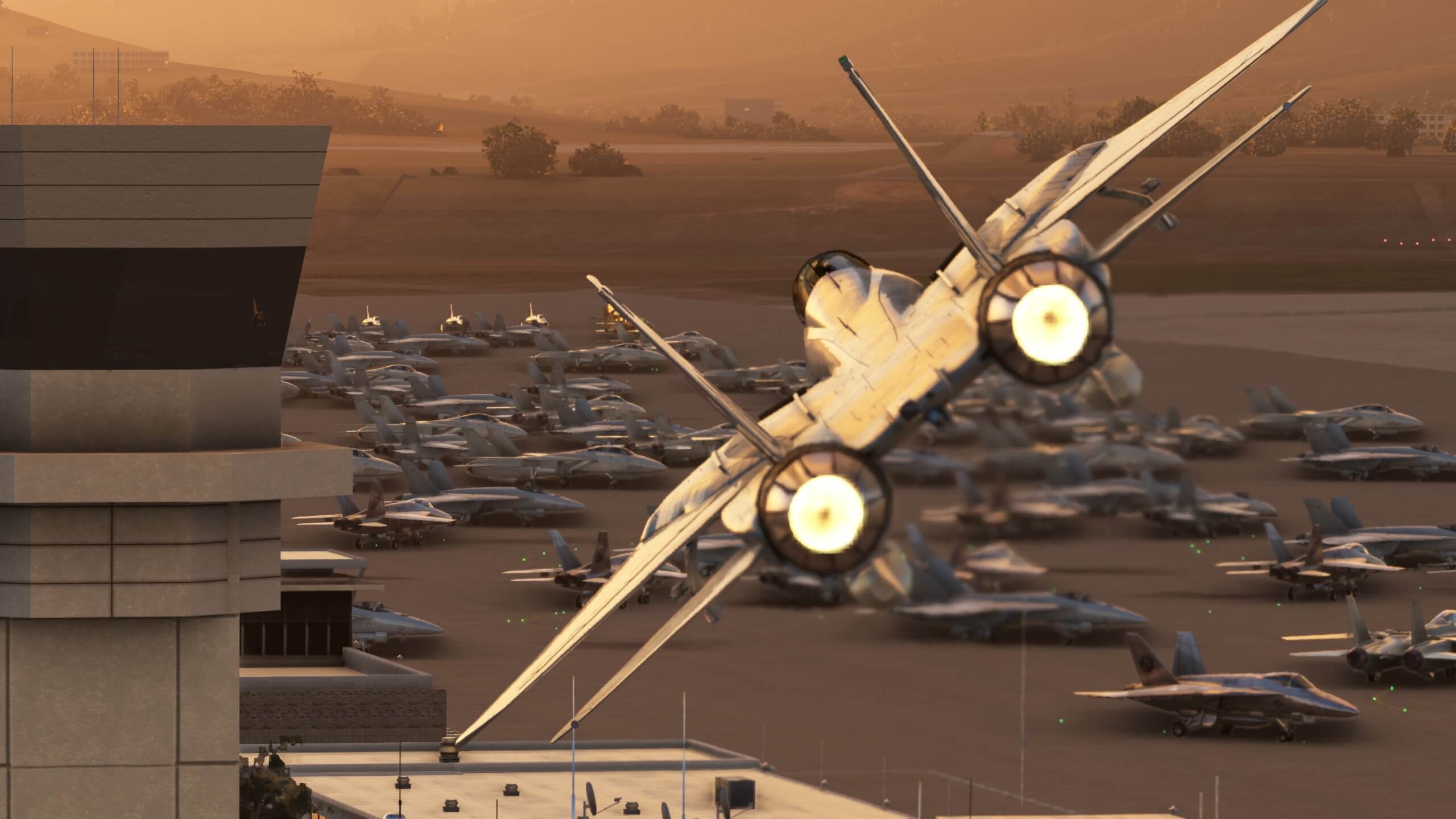 An F-14 Tomcat has afterburners engaged whilst passing close by an ATC tower