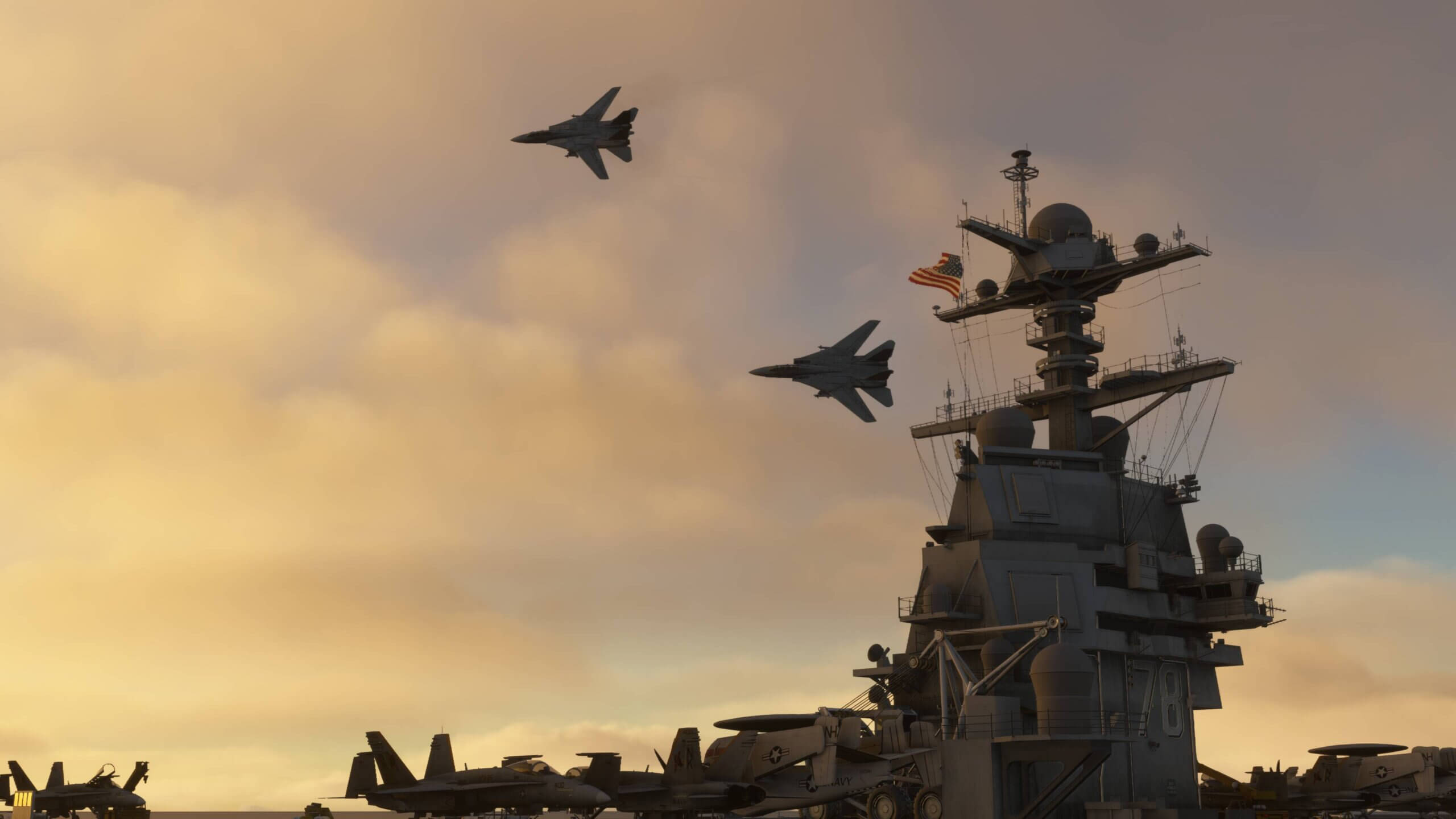 Two F-14 Tomcats fly in close formation over an aircraft carrier