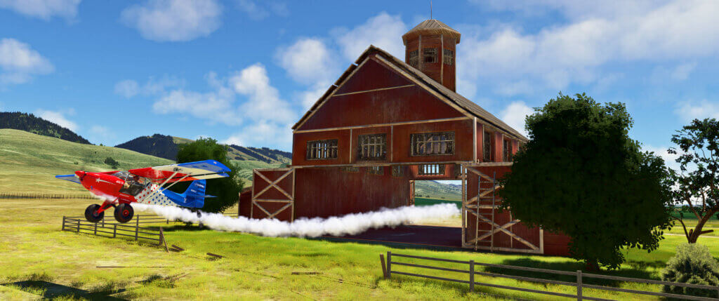 A plane with smoke on flies through a barn.