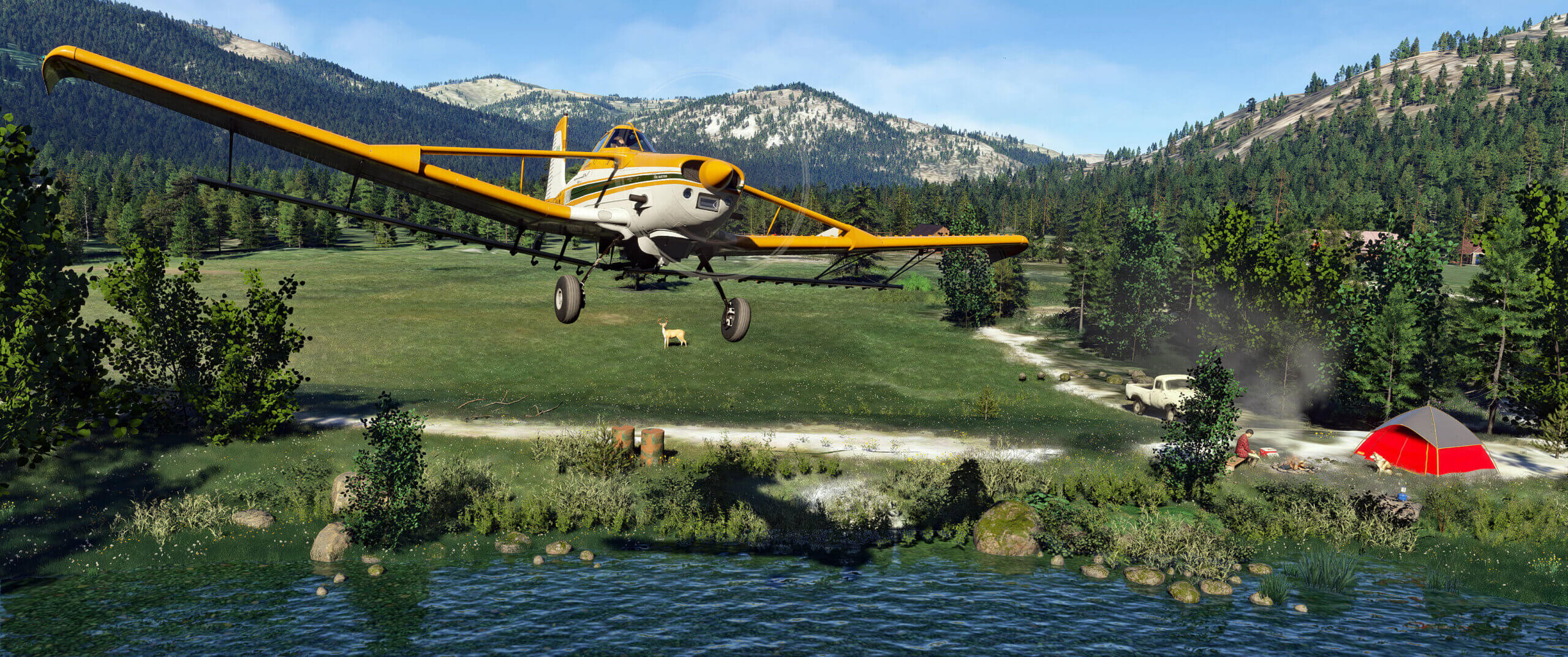 A yellow crop duster passes over a field with a man camping below
