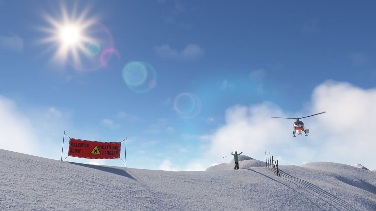 A skier atop a mountain waves at a helicopter.