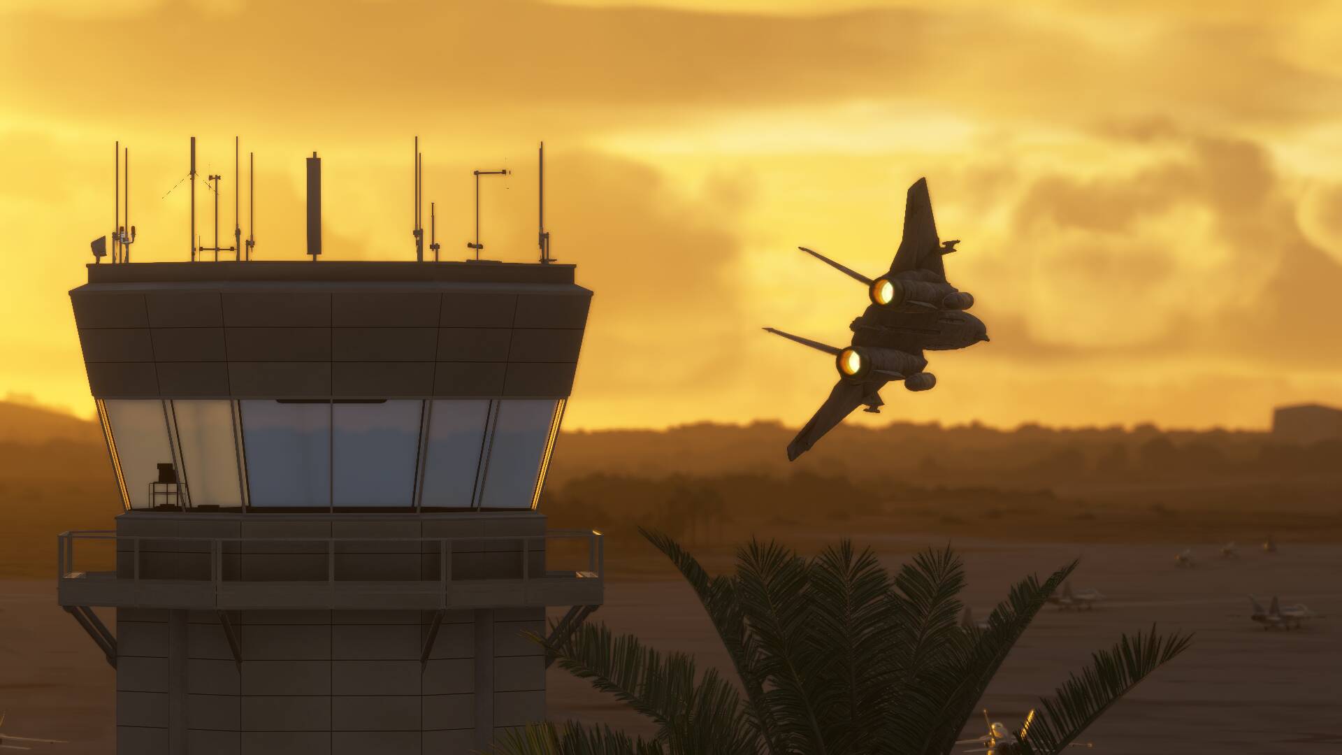An F-14 tomcat passes close to an ATC tower during sunset