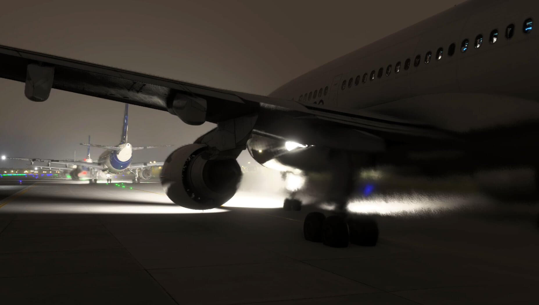 A queue of airliners on an airport taxiway at night
