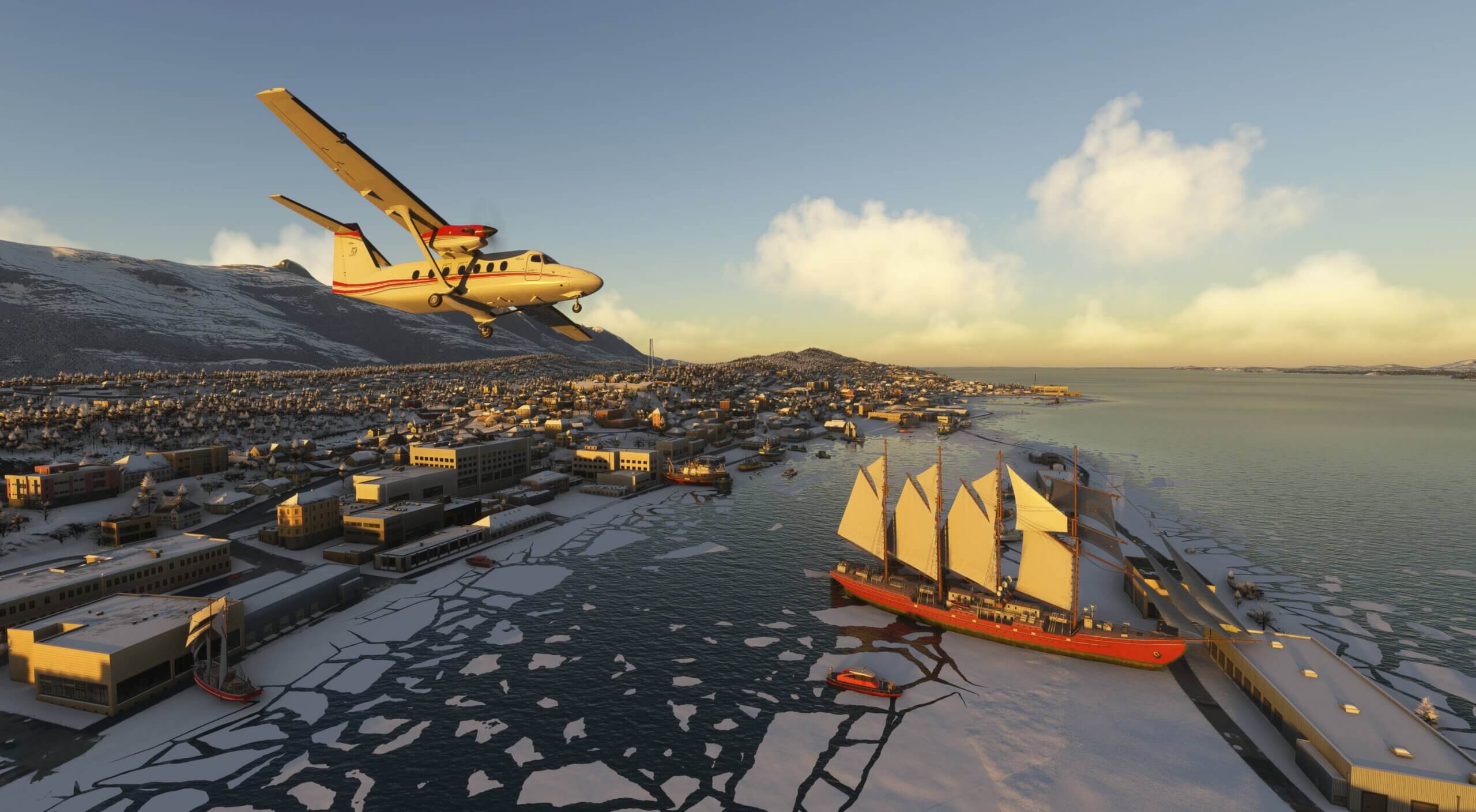 A dual propeller high wing aircraft flies low over a ship parked at harbour