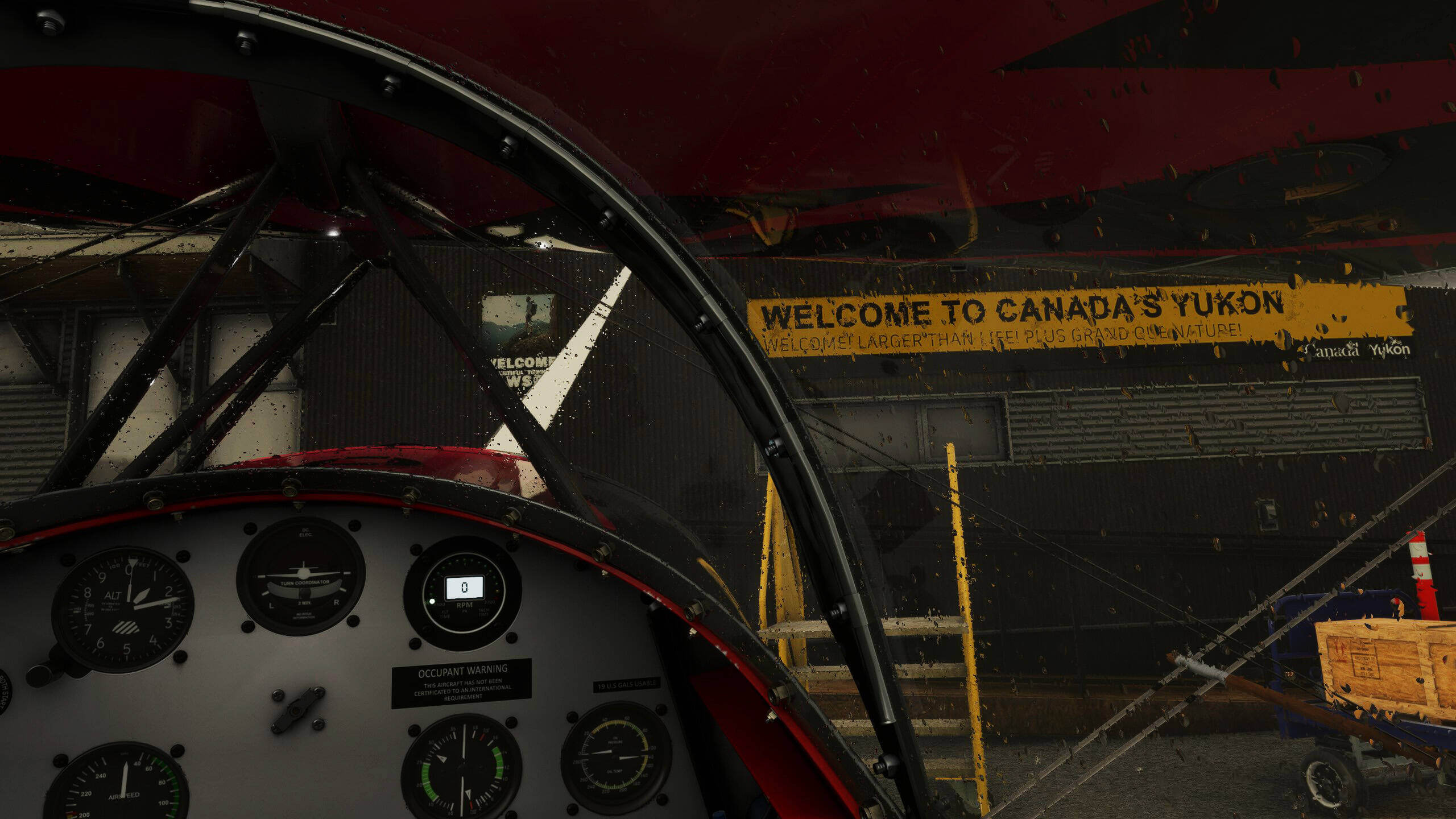 The view from the glass cockpit of an aircraft parked at an airport in Yukon, Canada