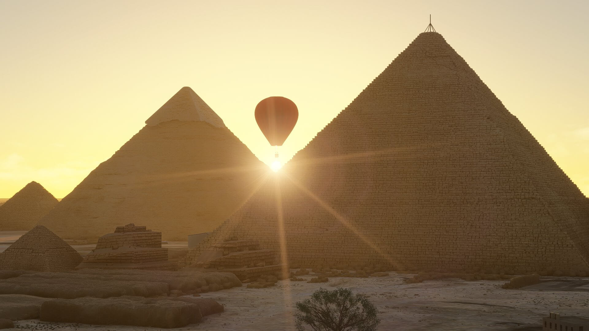 A Hot Air Balloon silhouetted by the sun, whilst flying next to the Pyramids of Giza, Egypt