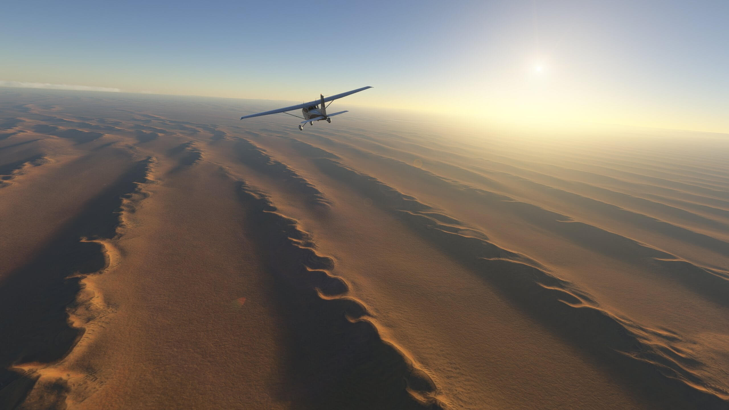 A Cessna 172 banks to the left whilst flying over a desert