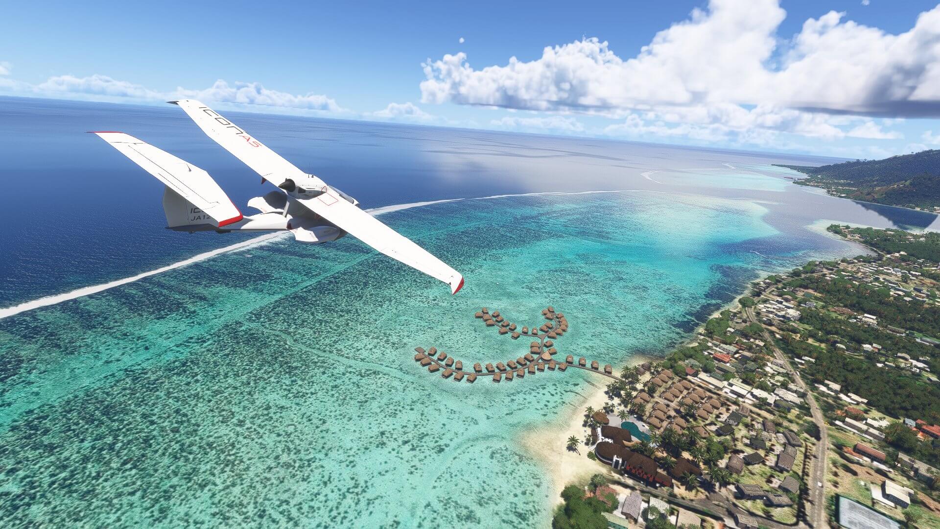 An Icon A5 cruises past a Caribbean island coastline