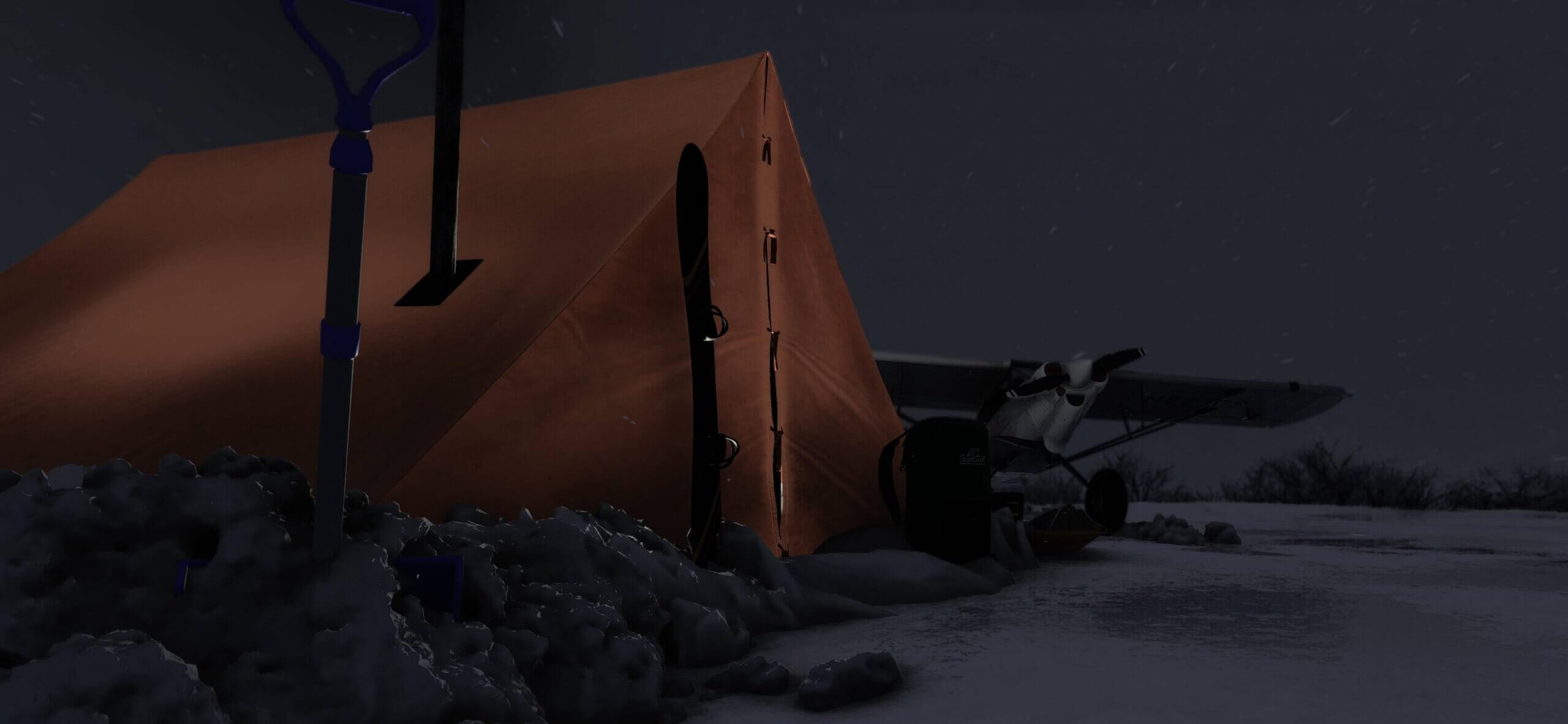 A propeller aircraft next to a tent during a snow storm