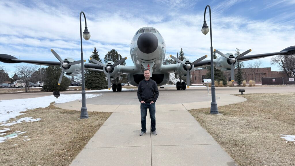 Cowtown standing in front of an aircraft