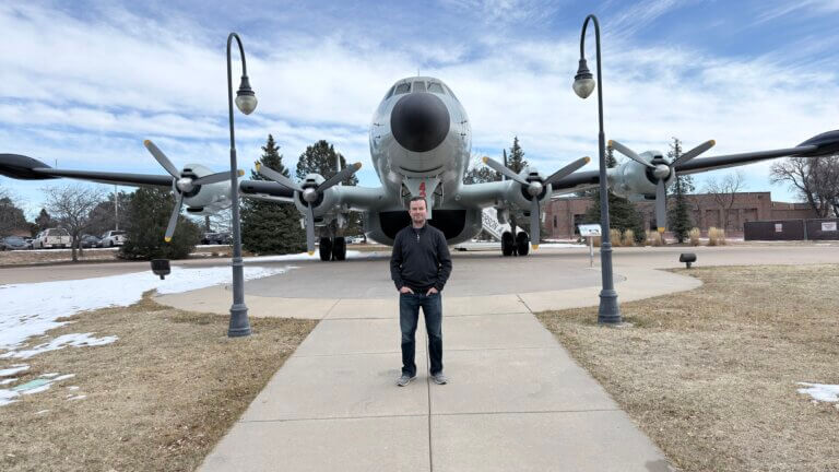 Cowtown standing in front of an aircraft