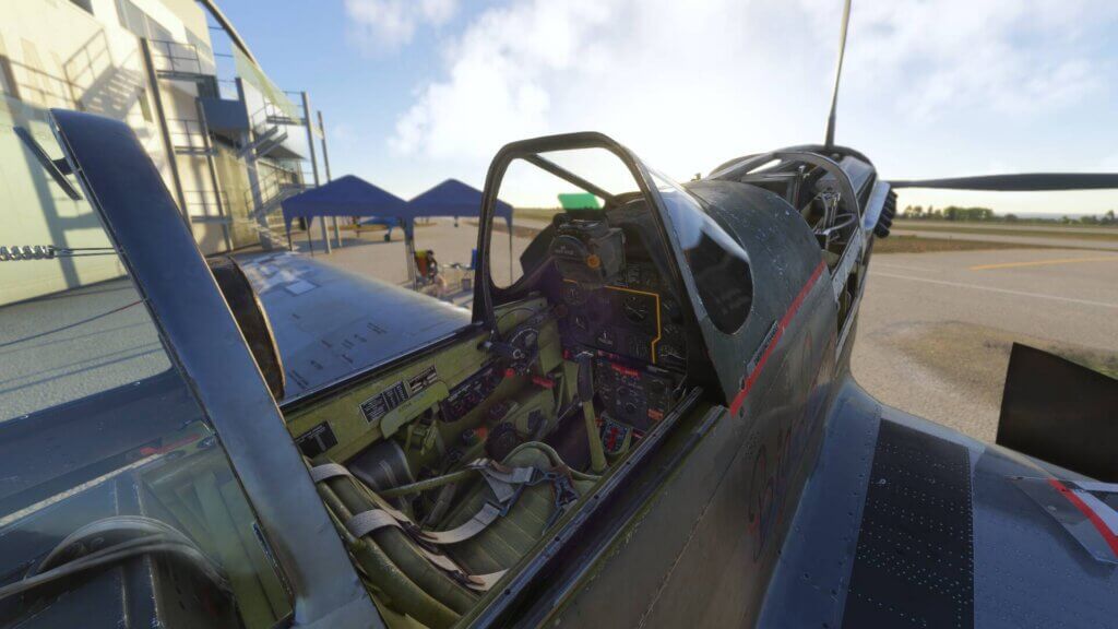 A warbird sitting idle on the ramp with its engine covers and canopy off