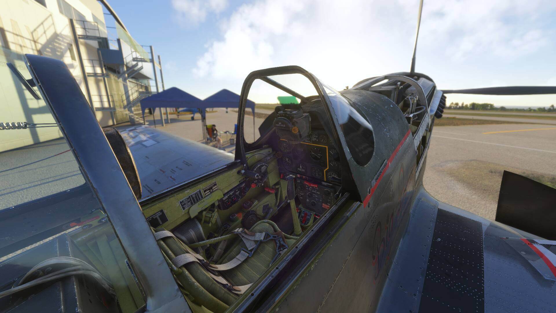 A warbird sitting idle on the ramp with its engine covers and canopy off