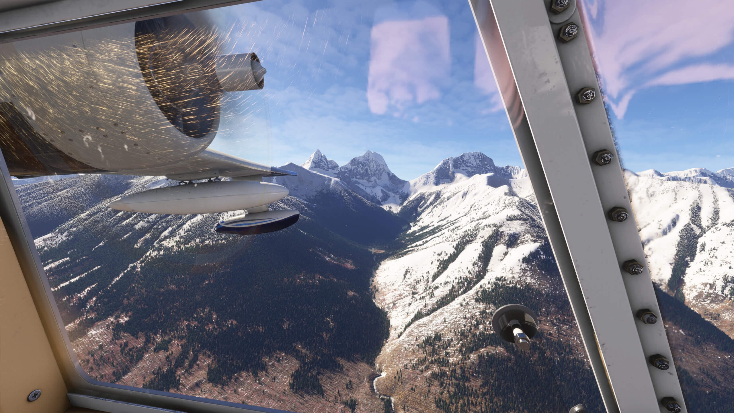 A wing view from a propeller aircraft looking out at a snowy mountain