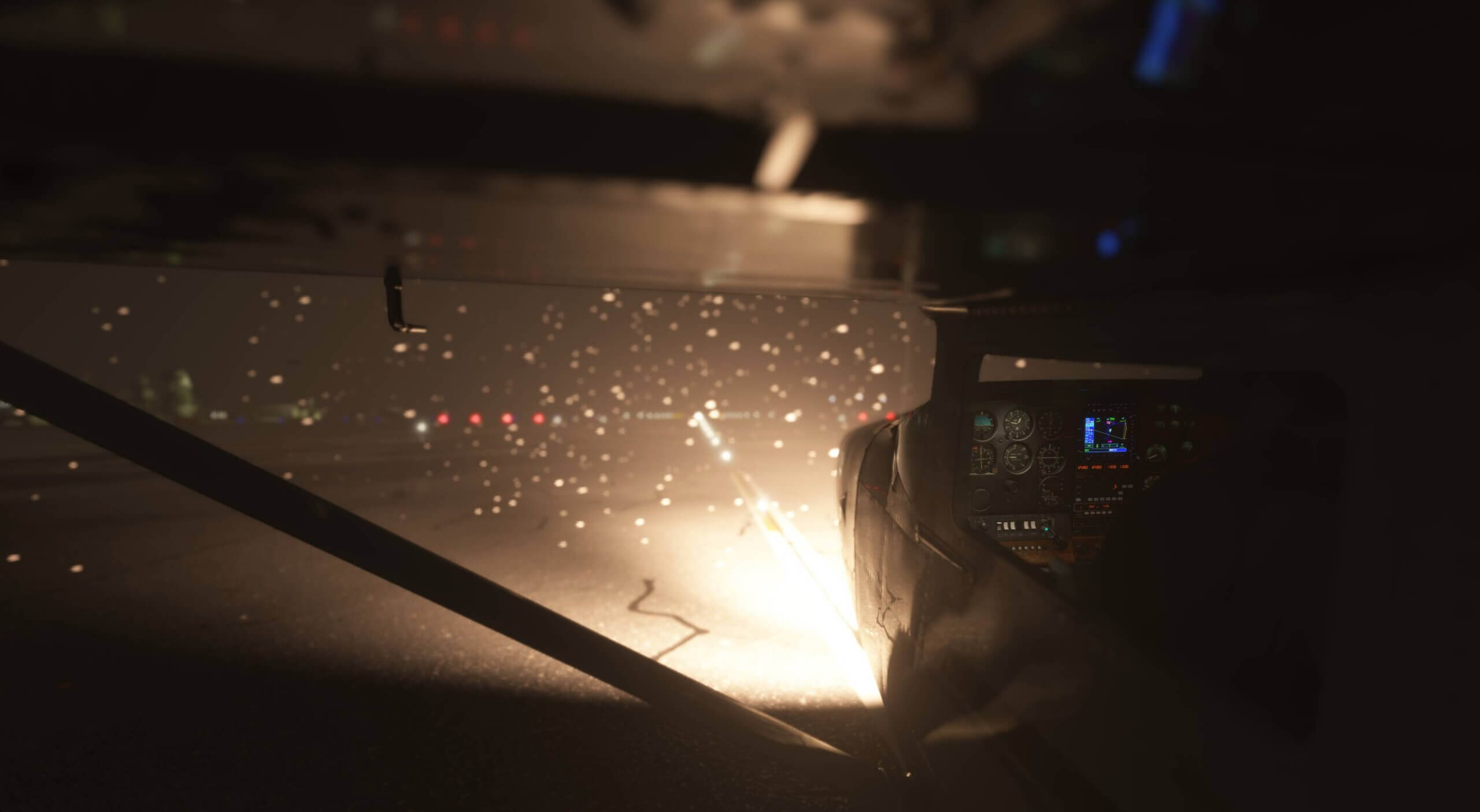 A Cessna propeller aircraft lights up the runway with its landing lights during a snow storm