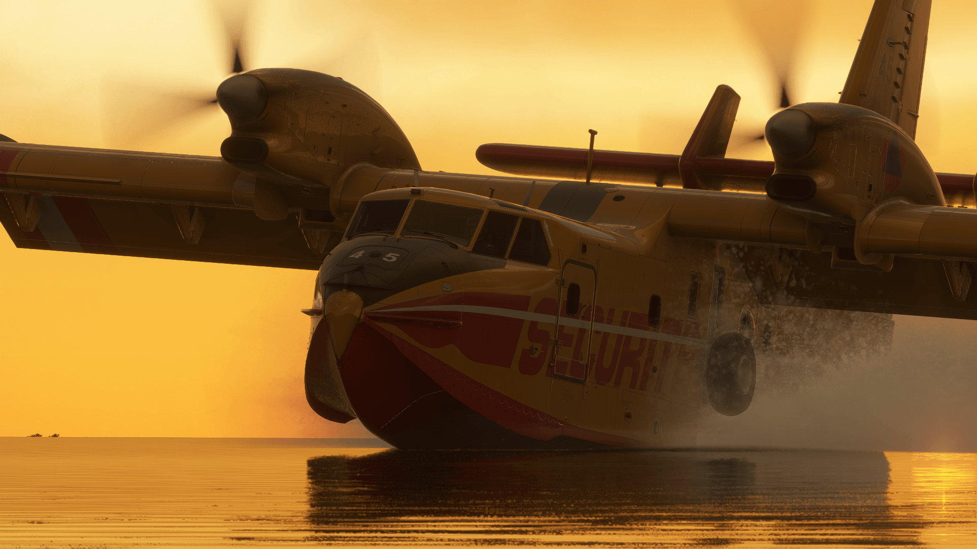 A CL-415 splashes down on water during golden hour