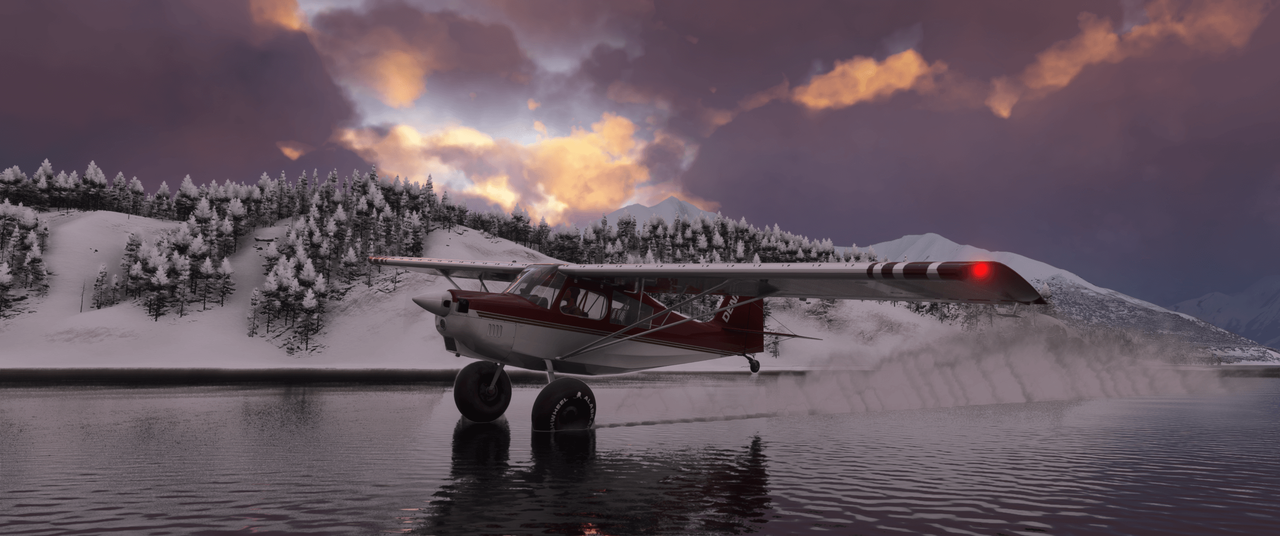 A high wing Cessna skims the surface of a lake near snow covered banks