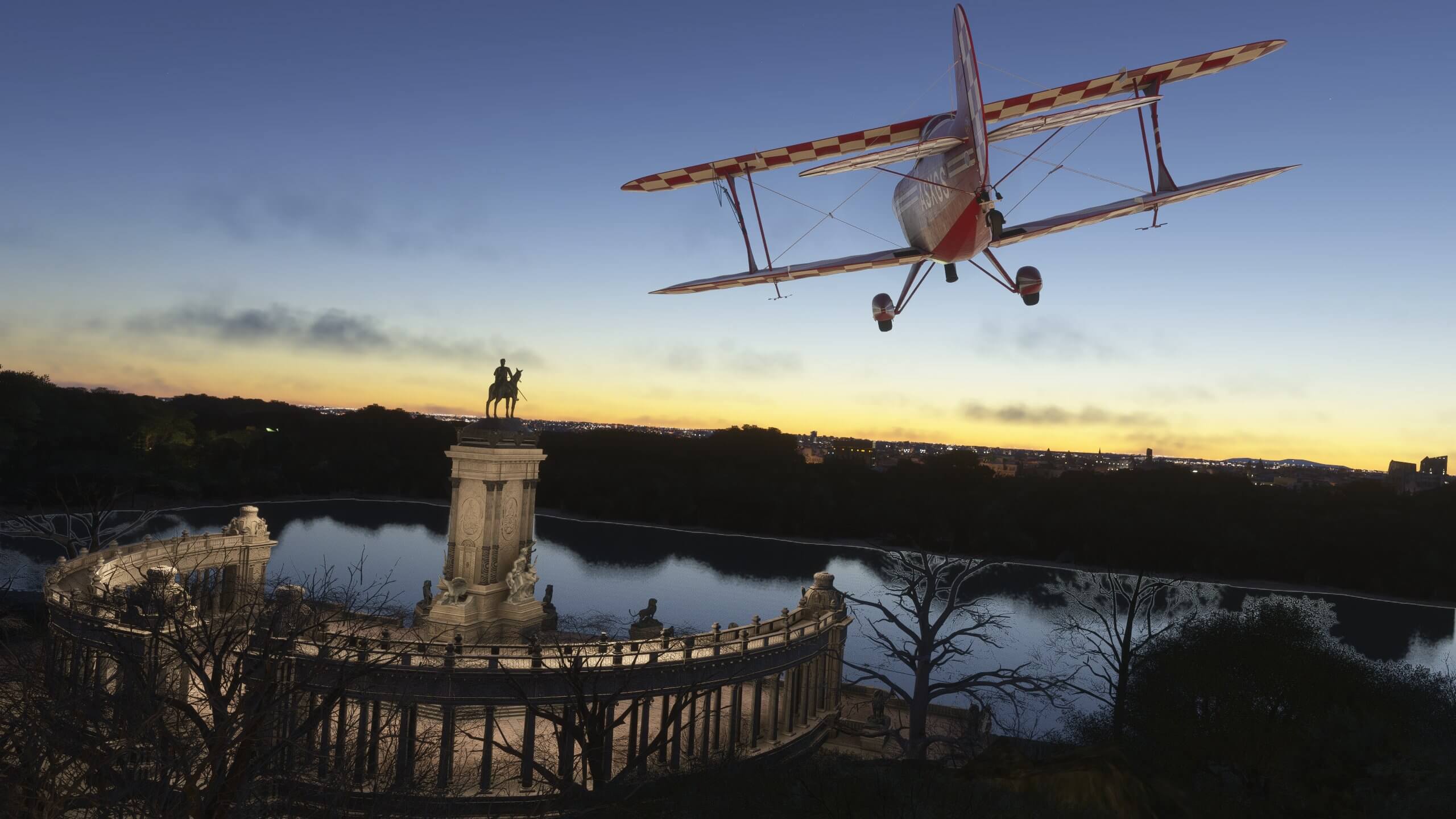 A dual wing propeller aircraft flies over a monument at dusk