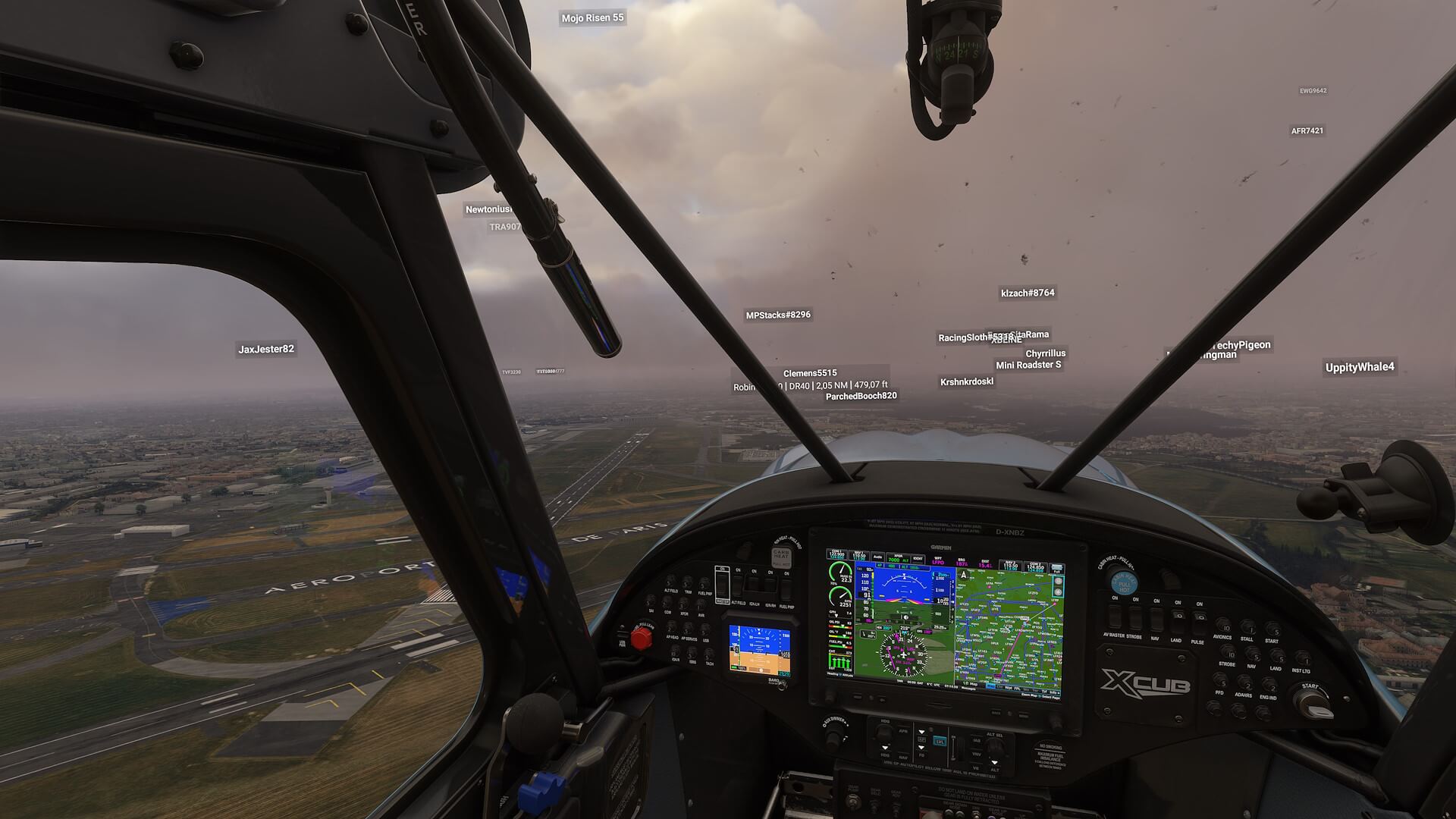An X-Cub flies over an airport in Paris, France