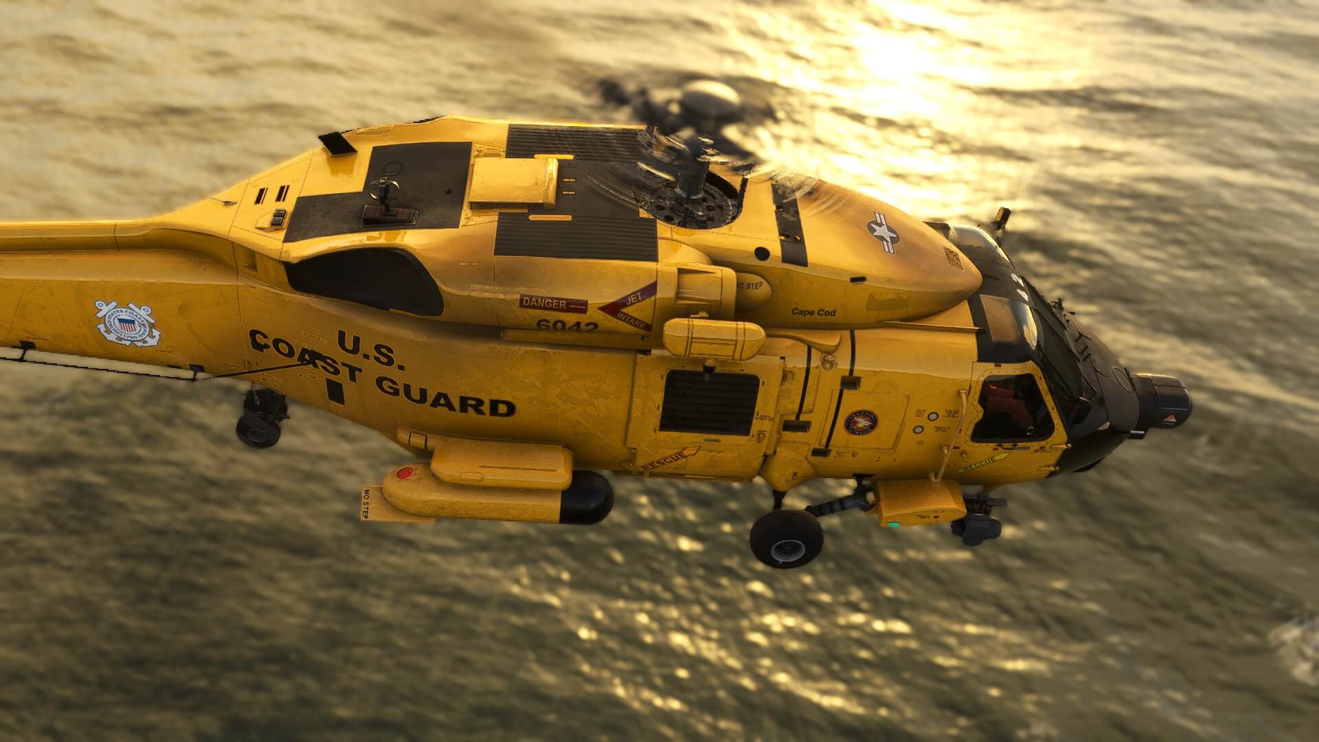 An MH-60 Helicopter flies low over water