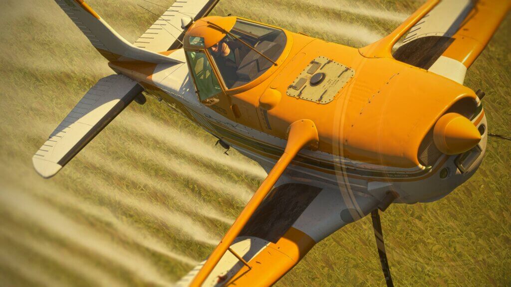 A crop dusting aircraft sprays a field