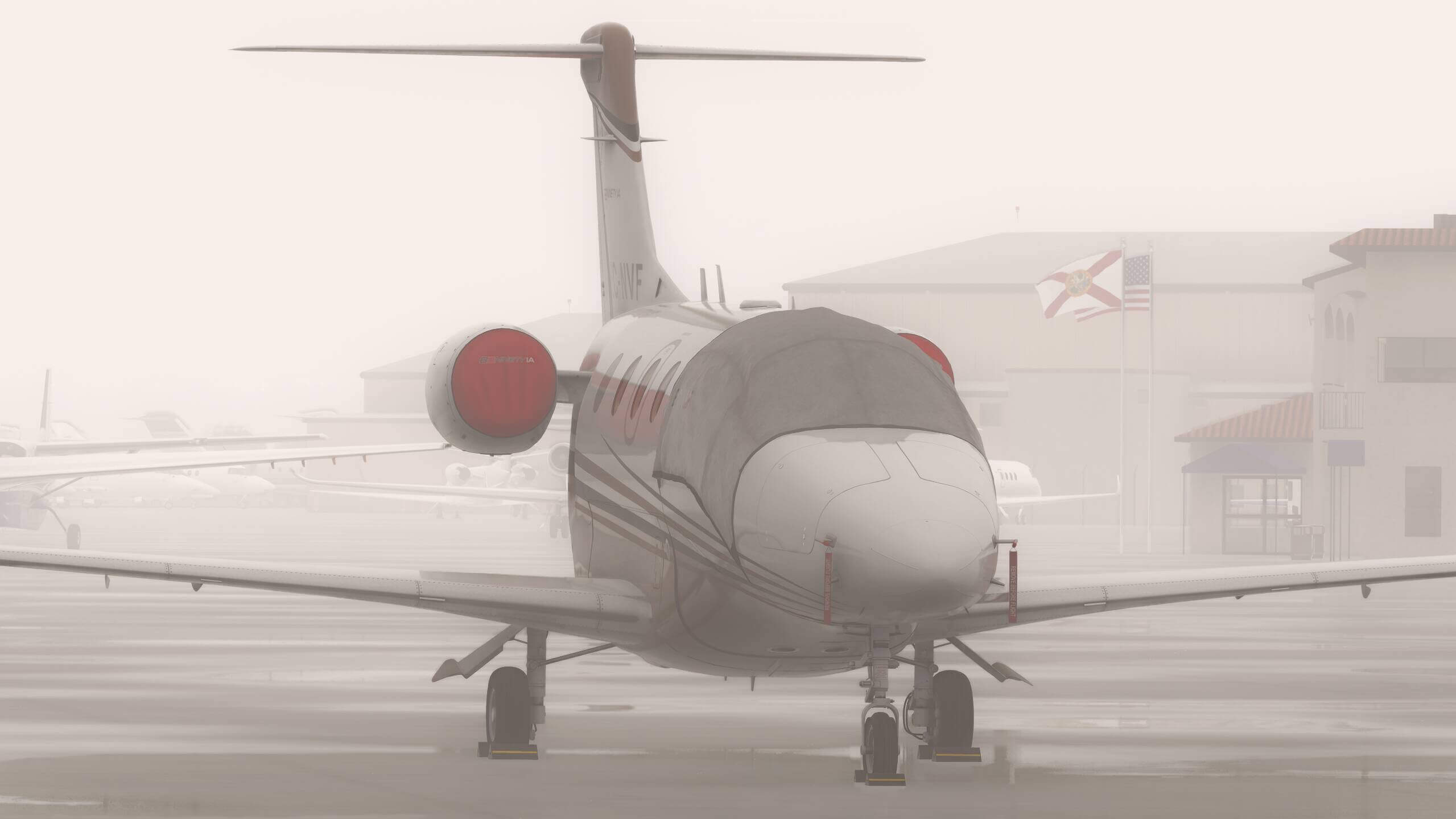 A business jet parked on a foggy apron