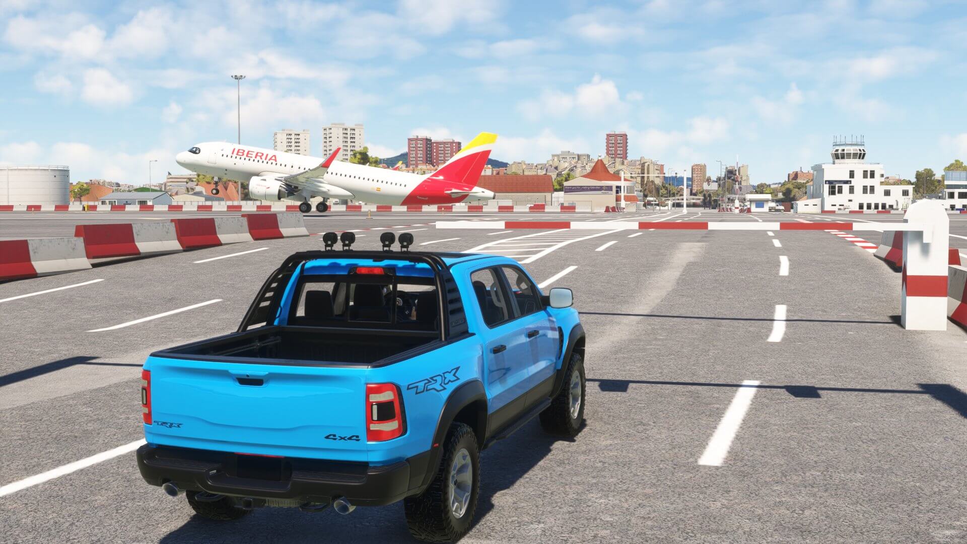 A 4x4 blue truck holds short of the runway at Gibraltar airport as an Airbus A320 takes off