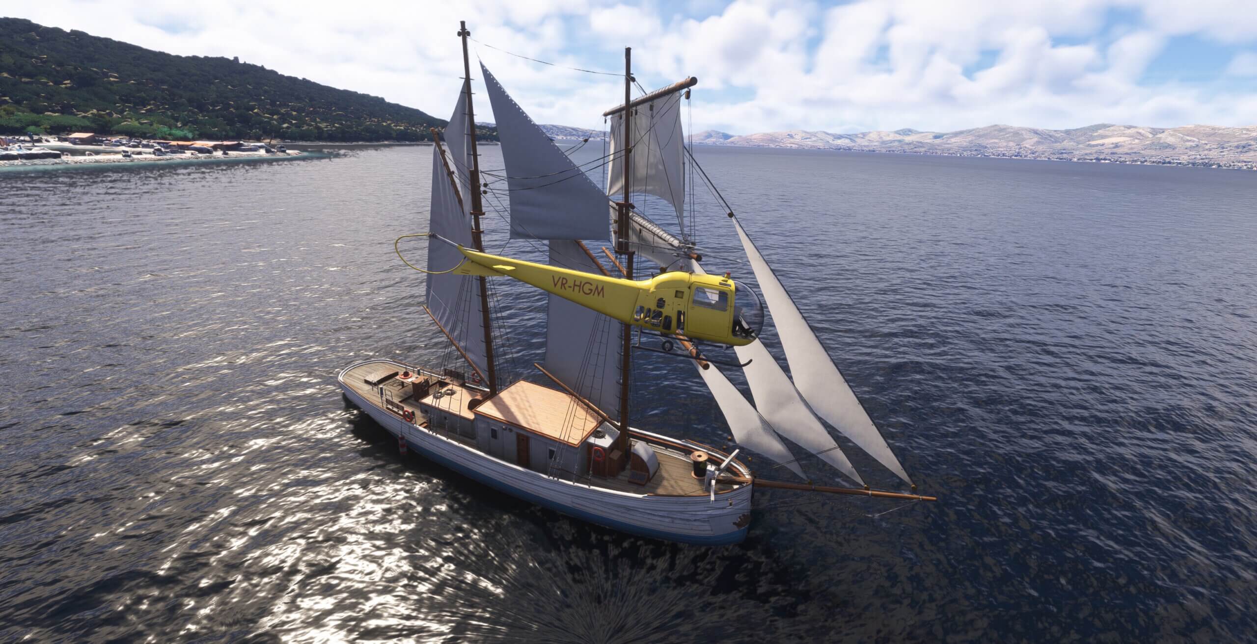 A yellow helicopter flies close to a yacht