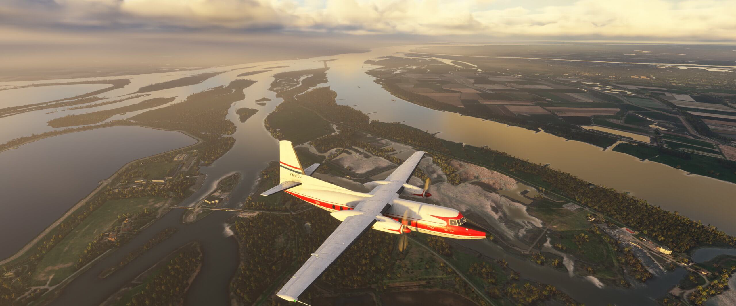 A Fokker F27 cruises over fields and rivers