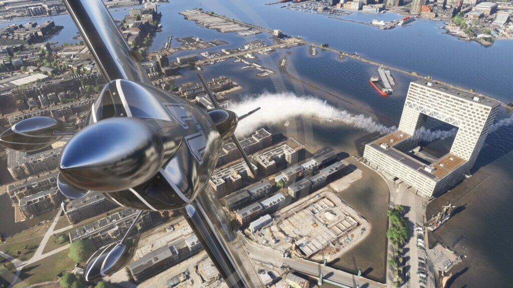 An aerobatic aircraft flies through a building with smoke plume trailing behind