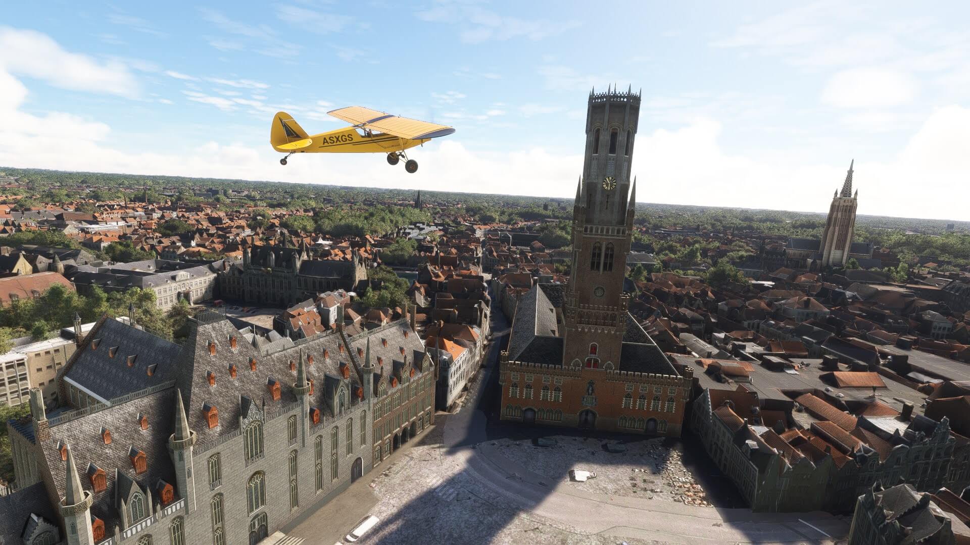 A yellow high wing propeller aircraft flies next to a church
