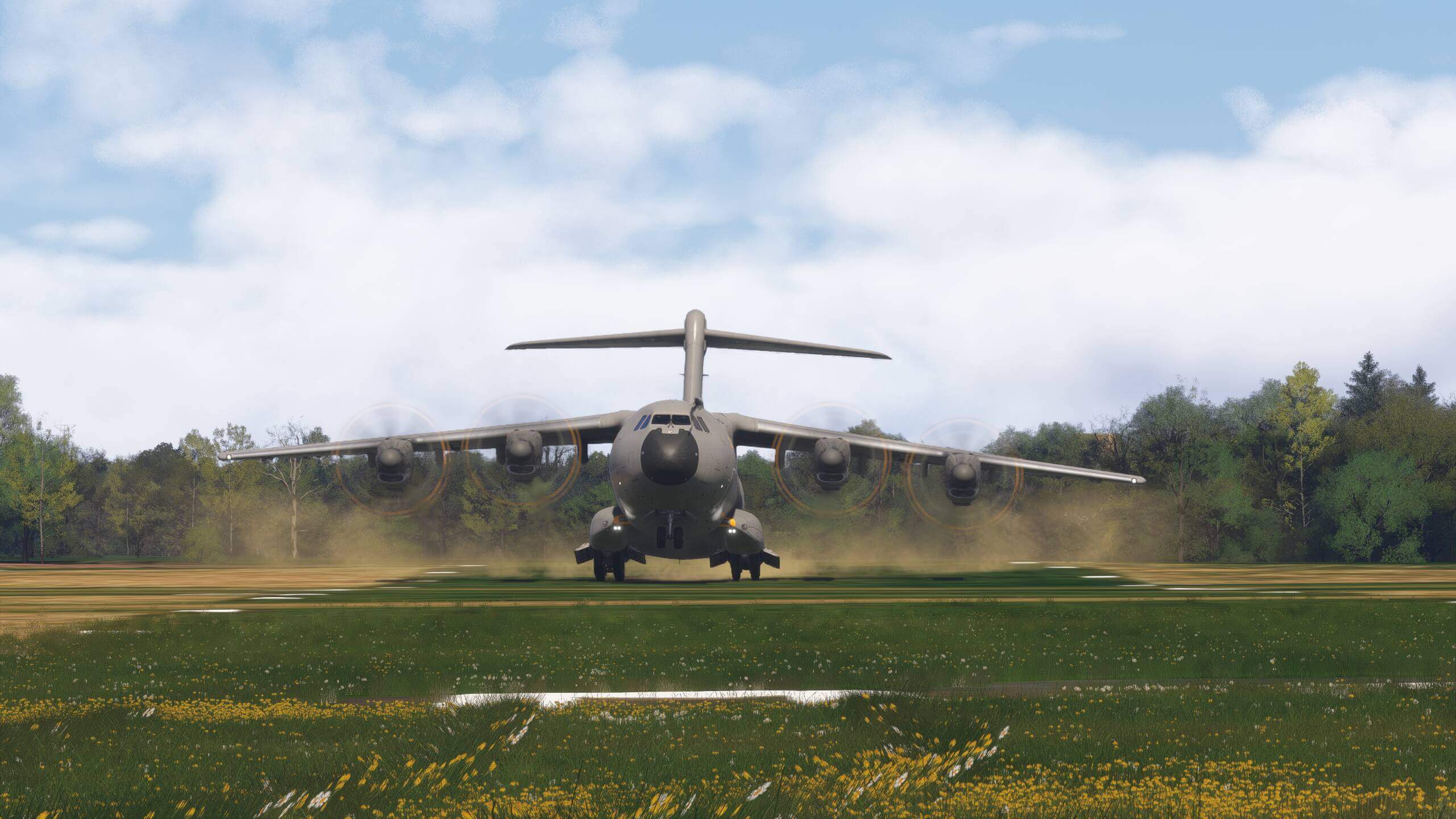An Airbus A400M rotates for takeoff on a grass strip runway