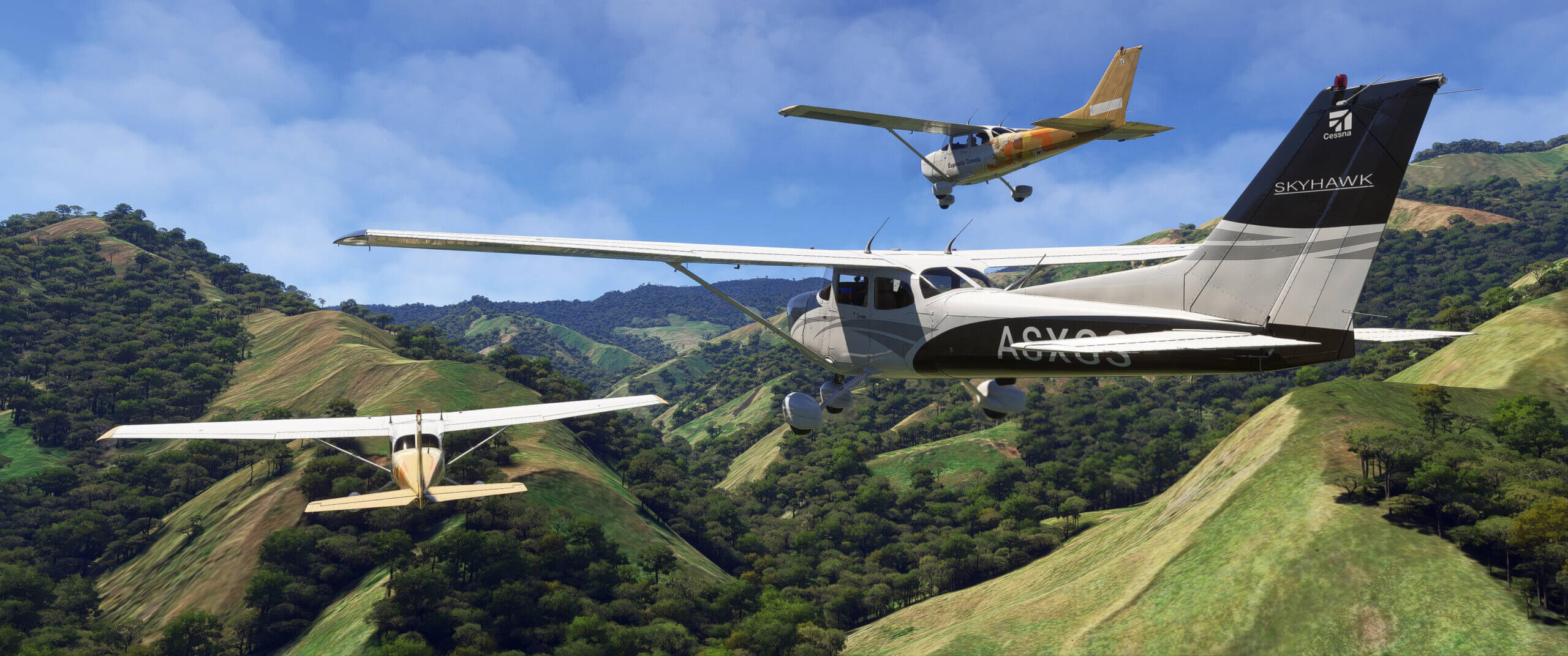 Cessna 172 aircraft fly in close formation through hilly terrain