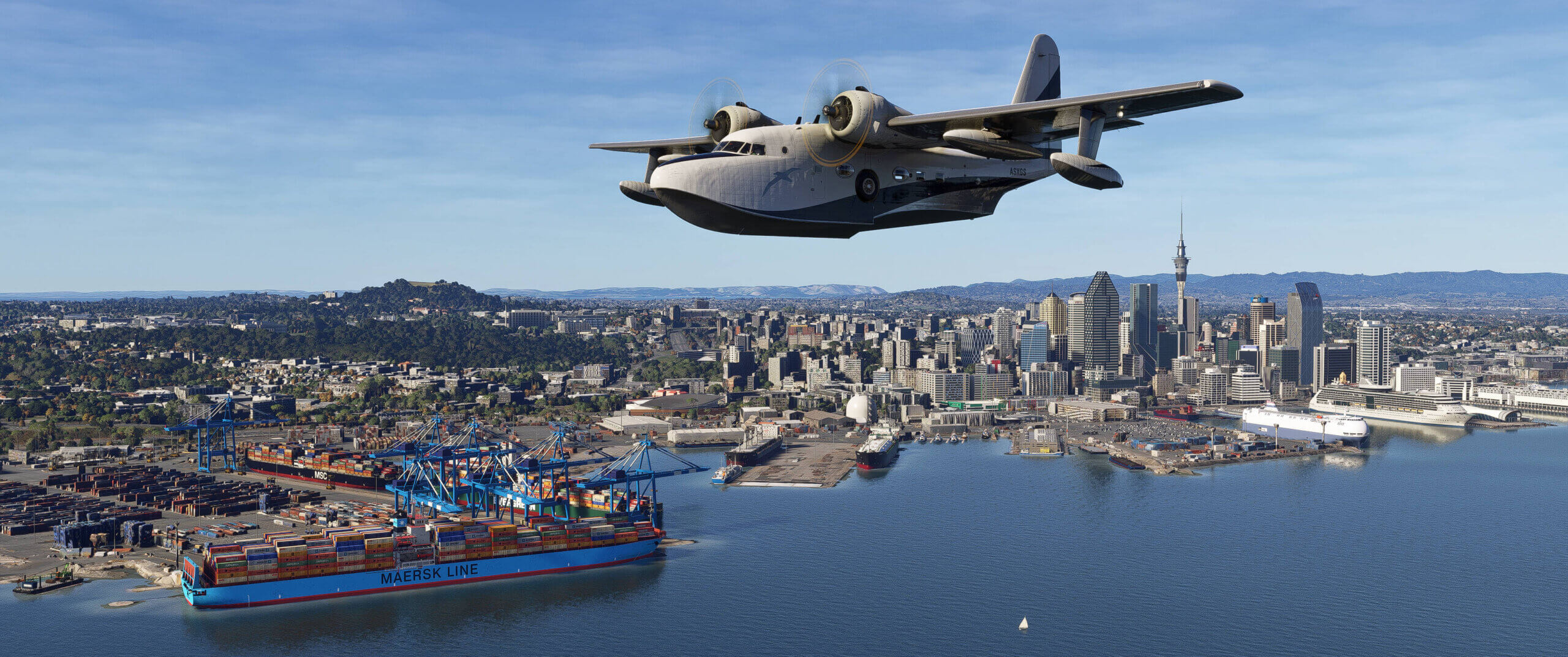 A high wing propeller aircraft flies low over a city scape