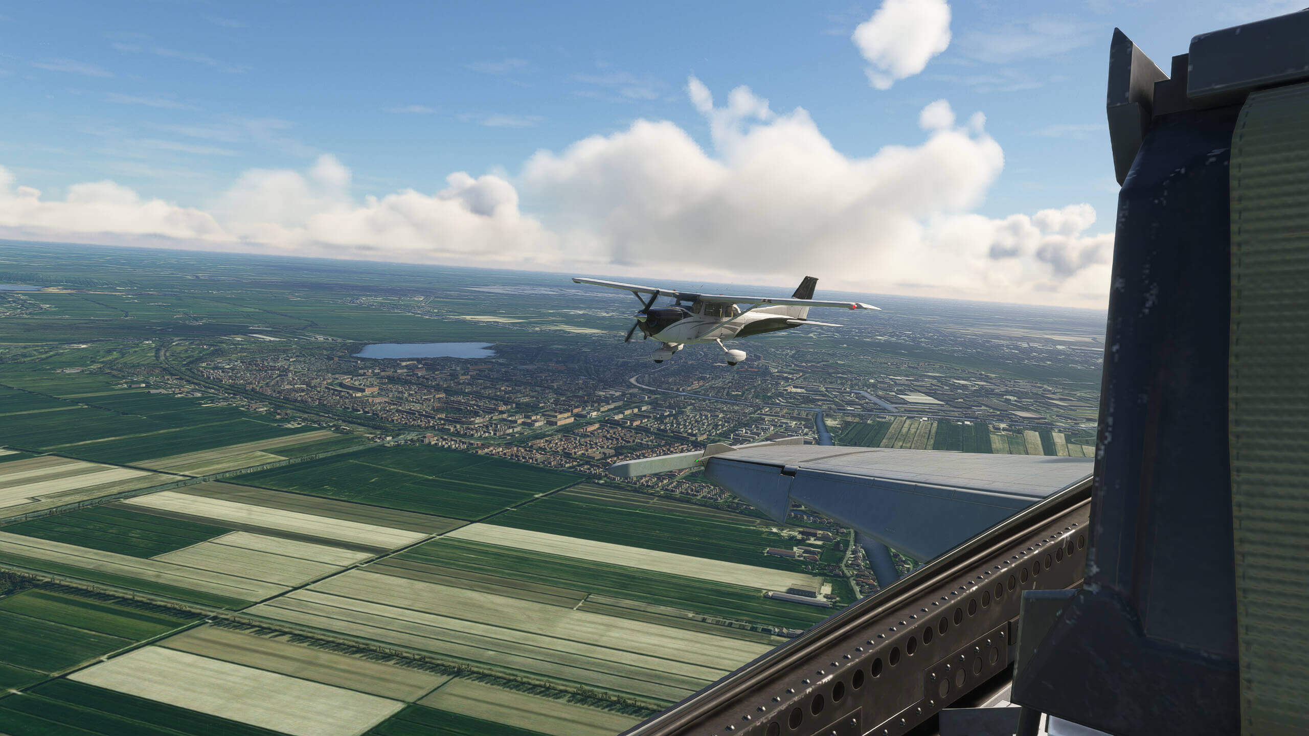 The wing view from an F/A-18 Hornet with a Cessna 172 flying in close formation