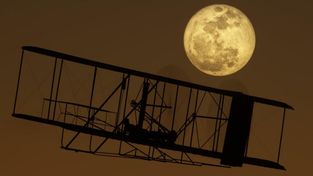 The Wright Brothers flyer silhouetted by the moon behind