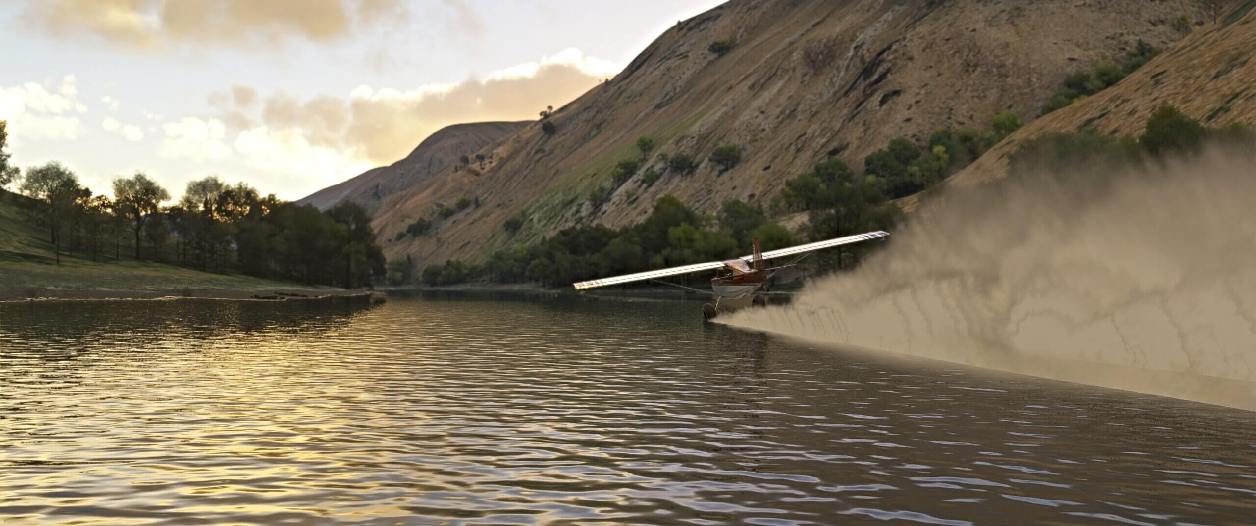 A high wing propeller aircraft skims the water with its wheels while flying through a valley