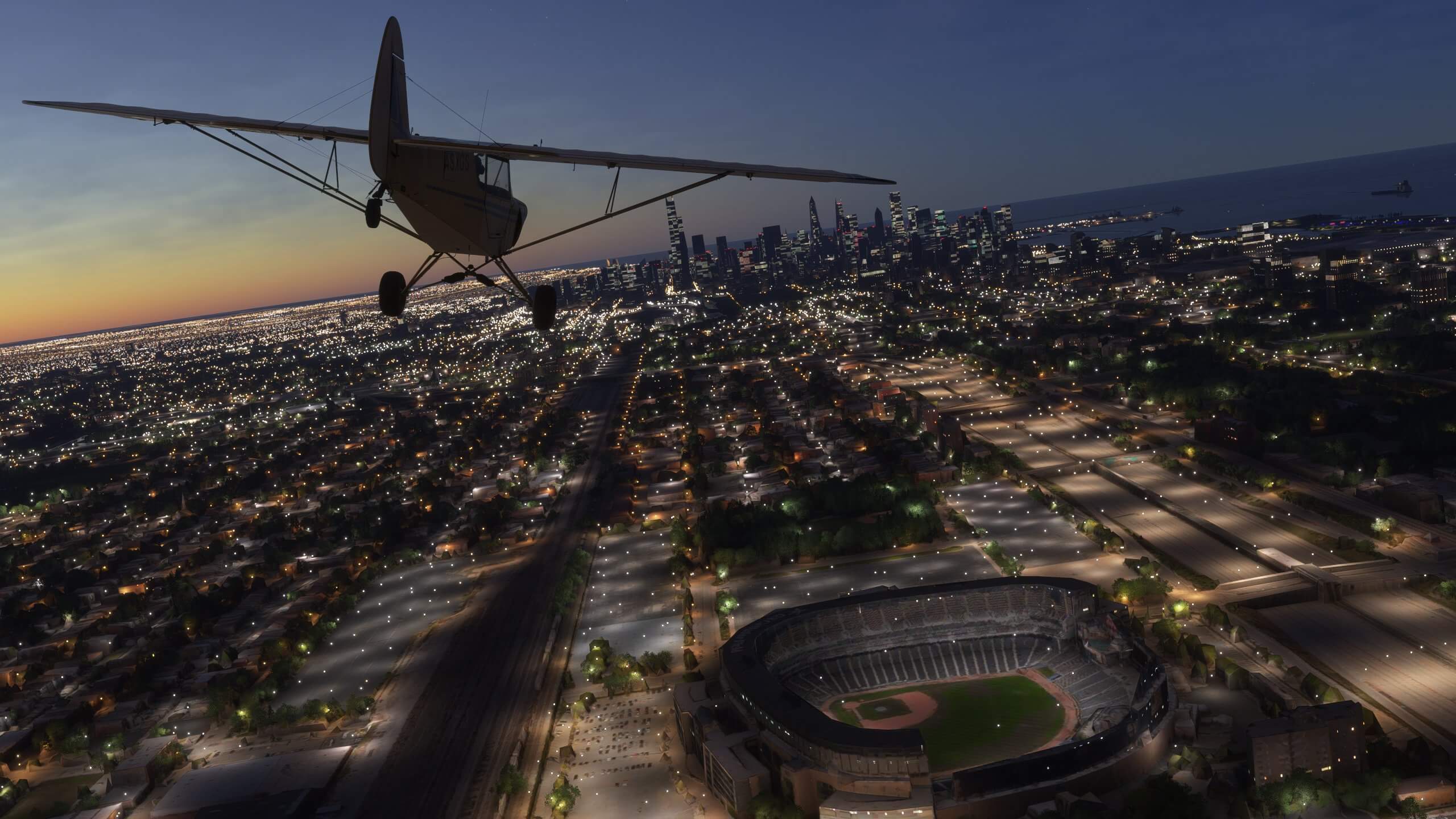 A high wing propeller aircraft flies over the city of Chicago