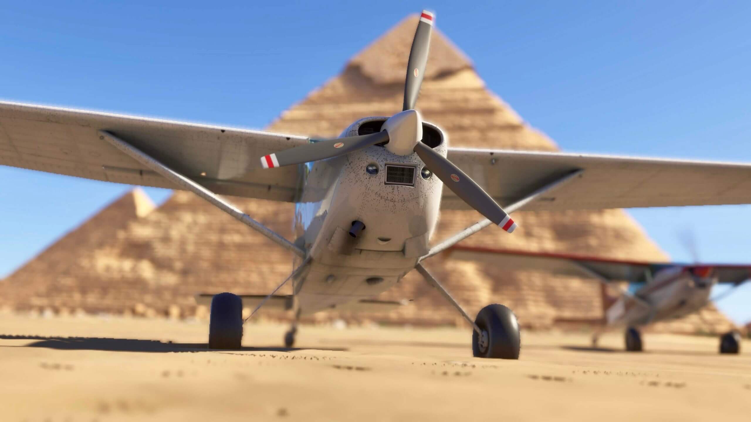 Two Cessna aircraft parked in front of the Pyramids of Giza, Egypt