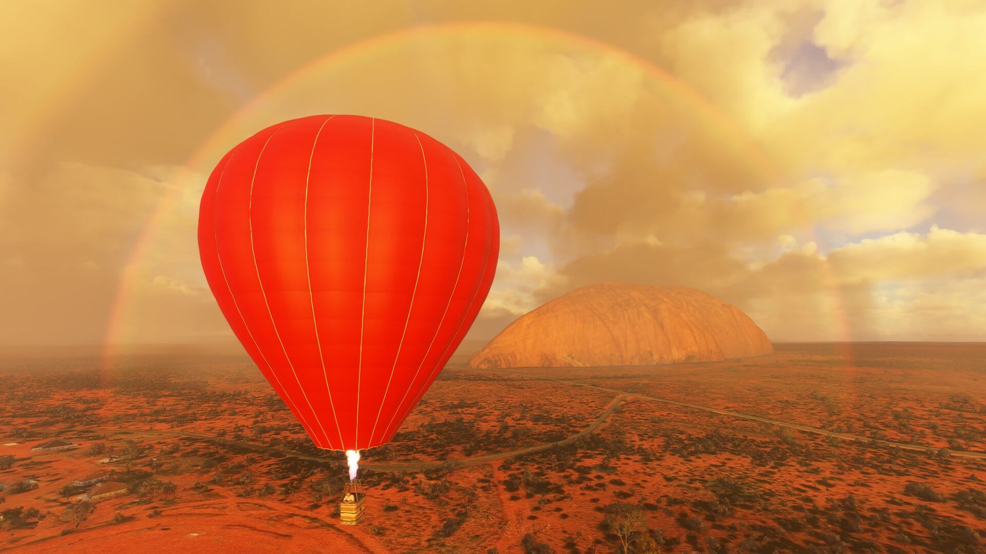 A Hot Air Balloon flies near Ayers Rock, Australia