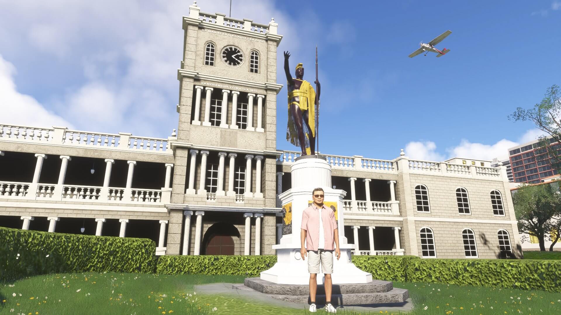 A man stands by a statue in Hawaii with a propeller plane flying overhead