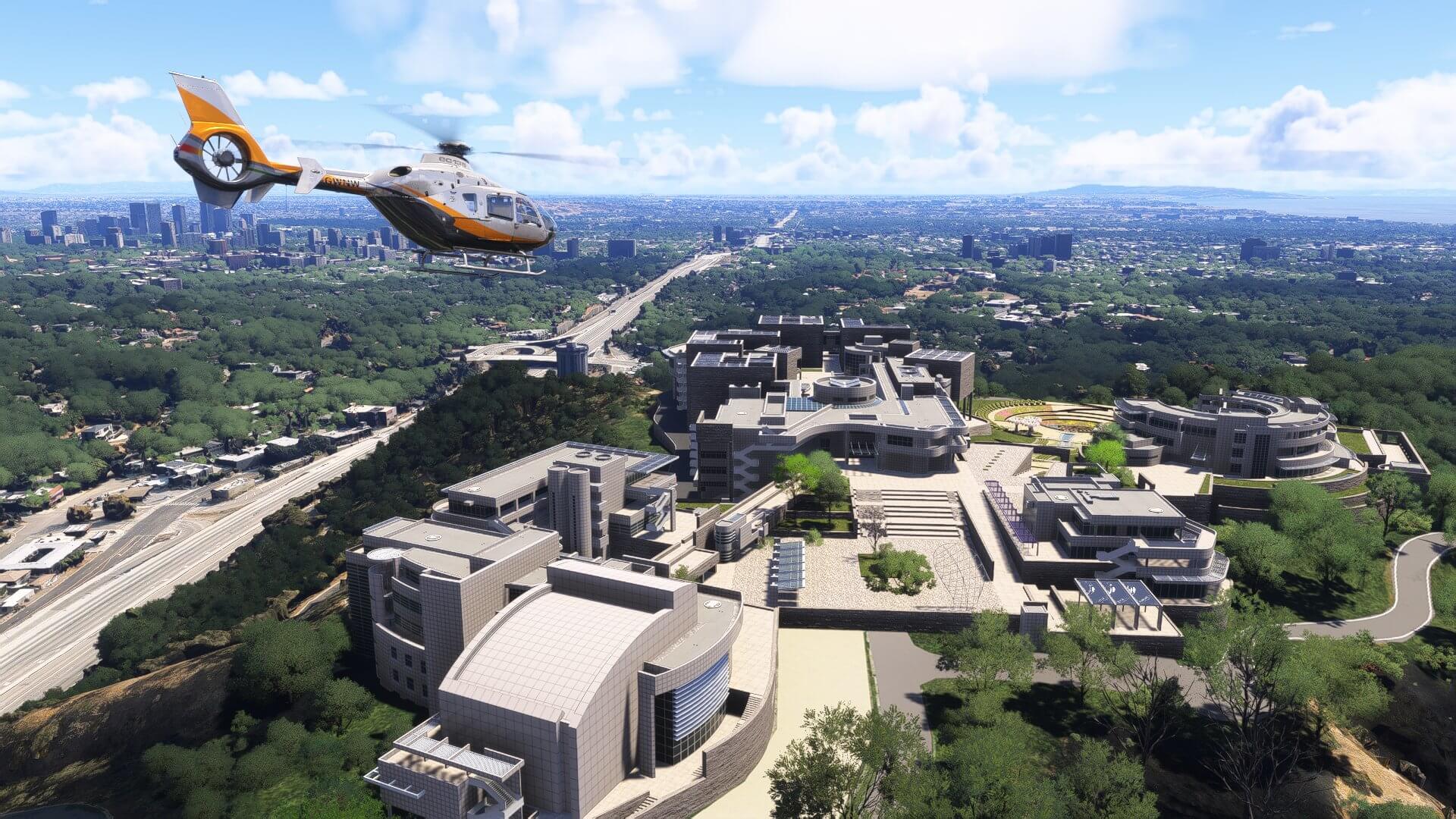 An EC135 helicopter flies over Los Angeles city