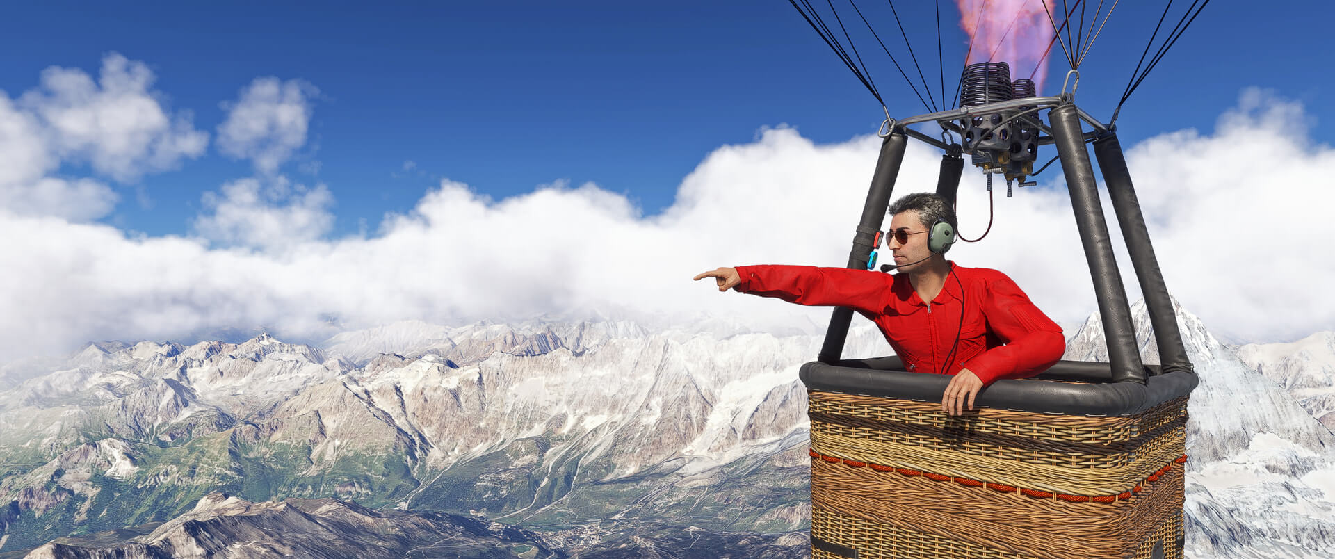 A man in a red shirt points out of a hot air balloon